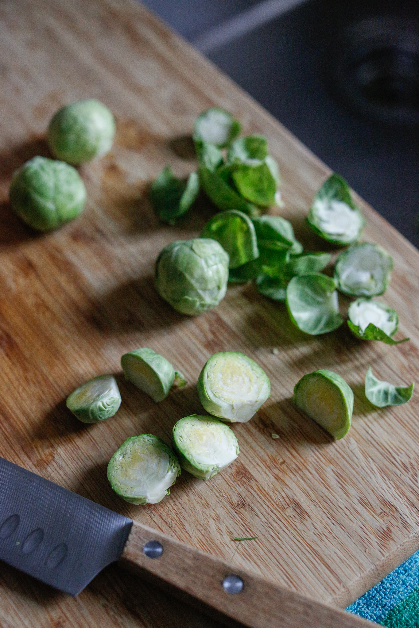 Cut brussels sprouts in half and put them directly on your sheet pan