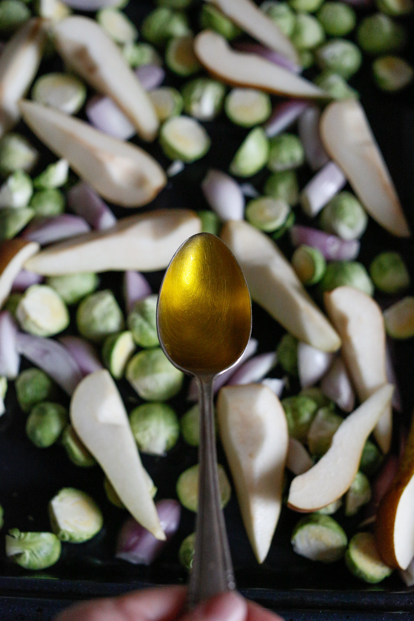 Drizzle your olive oil over your sheet pan and with your hands, mix it all up to coat everything
