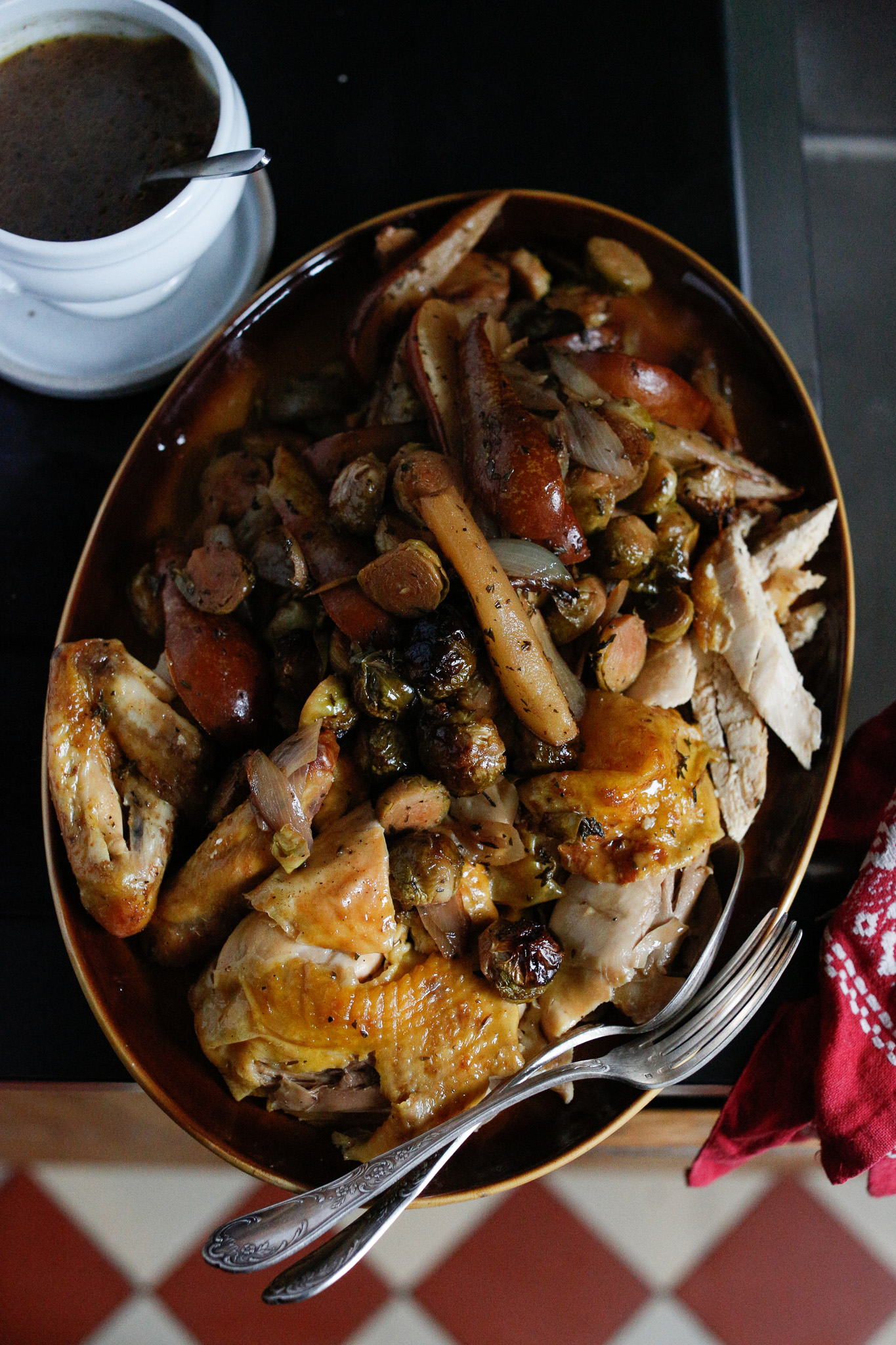 Chicken ready for serving pears shallots and brussels sprouts