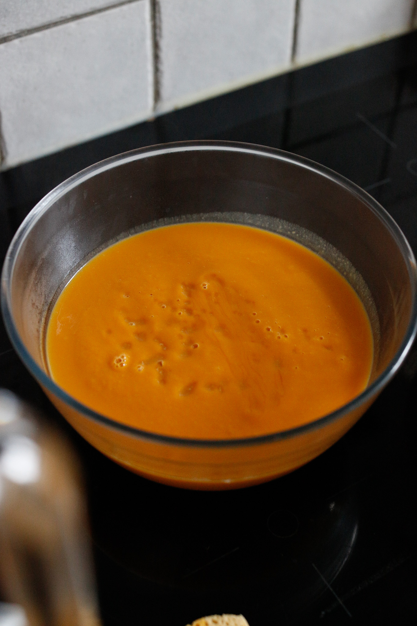 You'll most likely have to blend in batches, so use a bowl to store your blended soup until your soup pot is free
