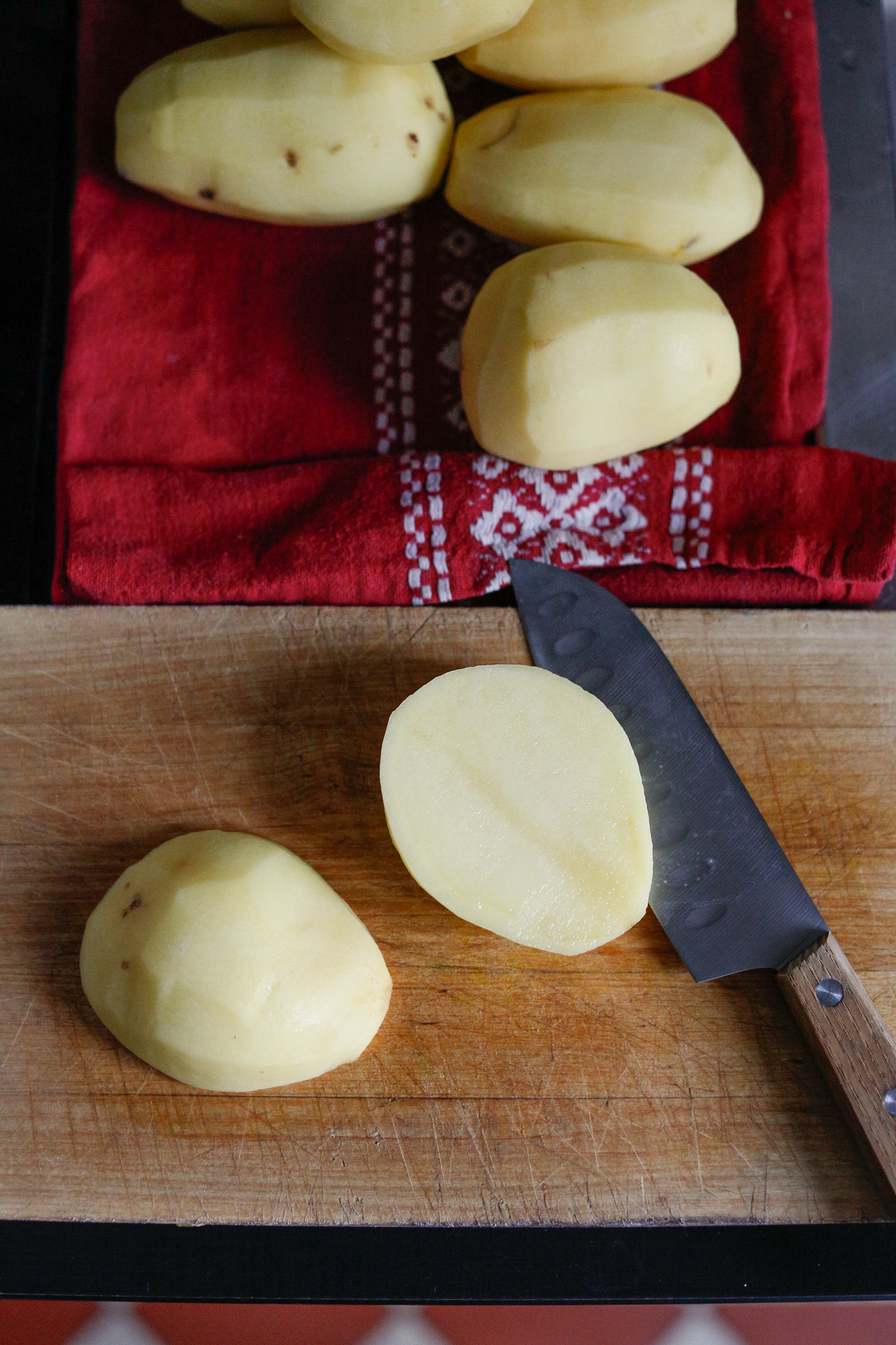 Peel all of your potatoes and cut them in half before cubing them