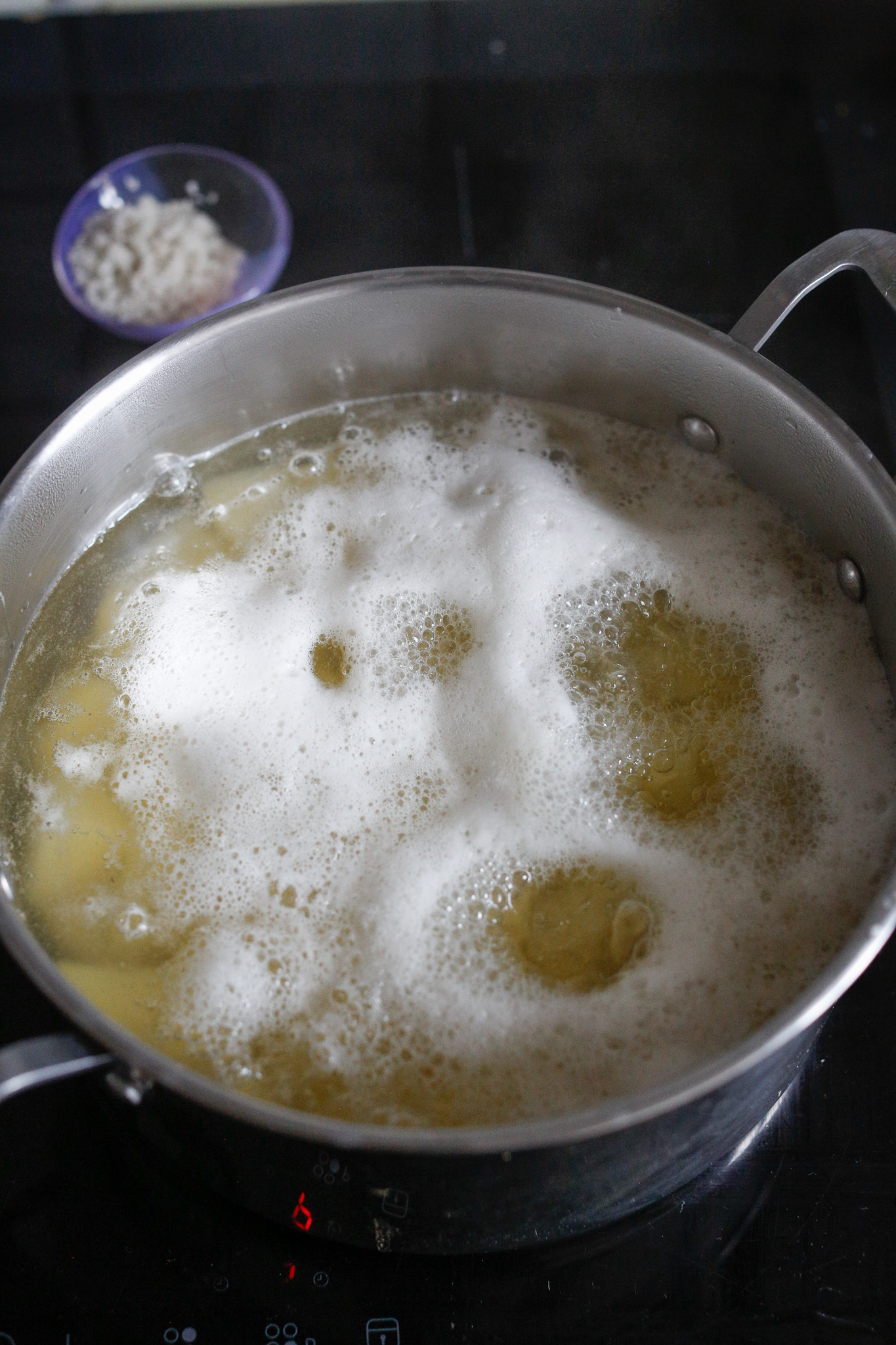 Foam may rise to the top of the water. This is the starch emerging from the potatoes. There is no need to skim it off