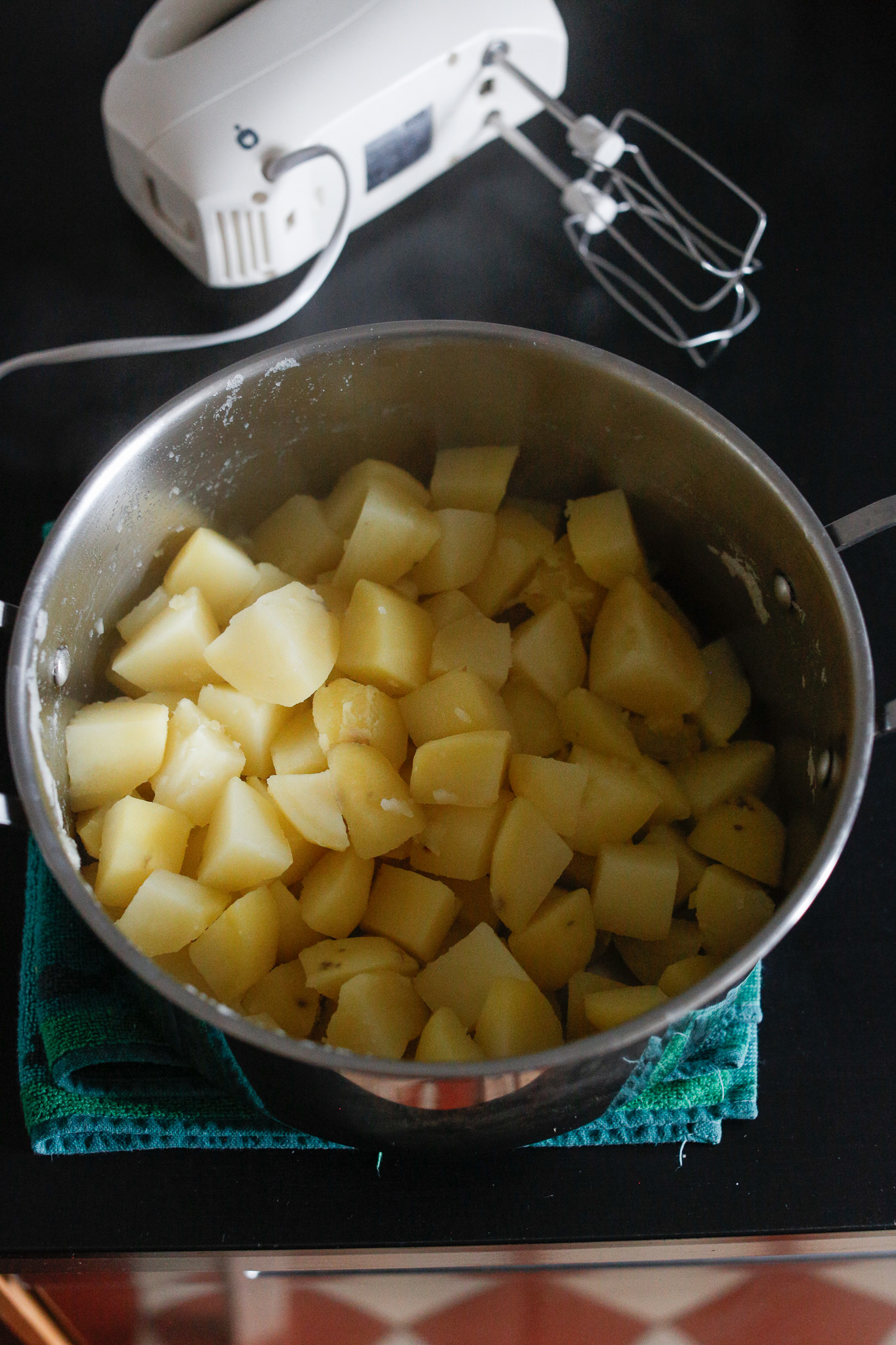 Back in the pot with your hand held beater to pre-crush your potatoes