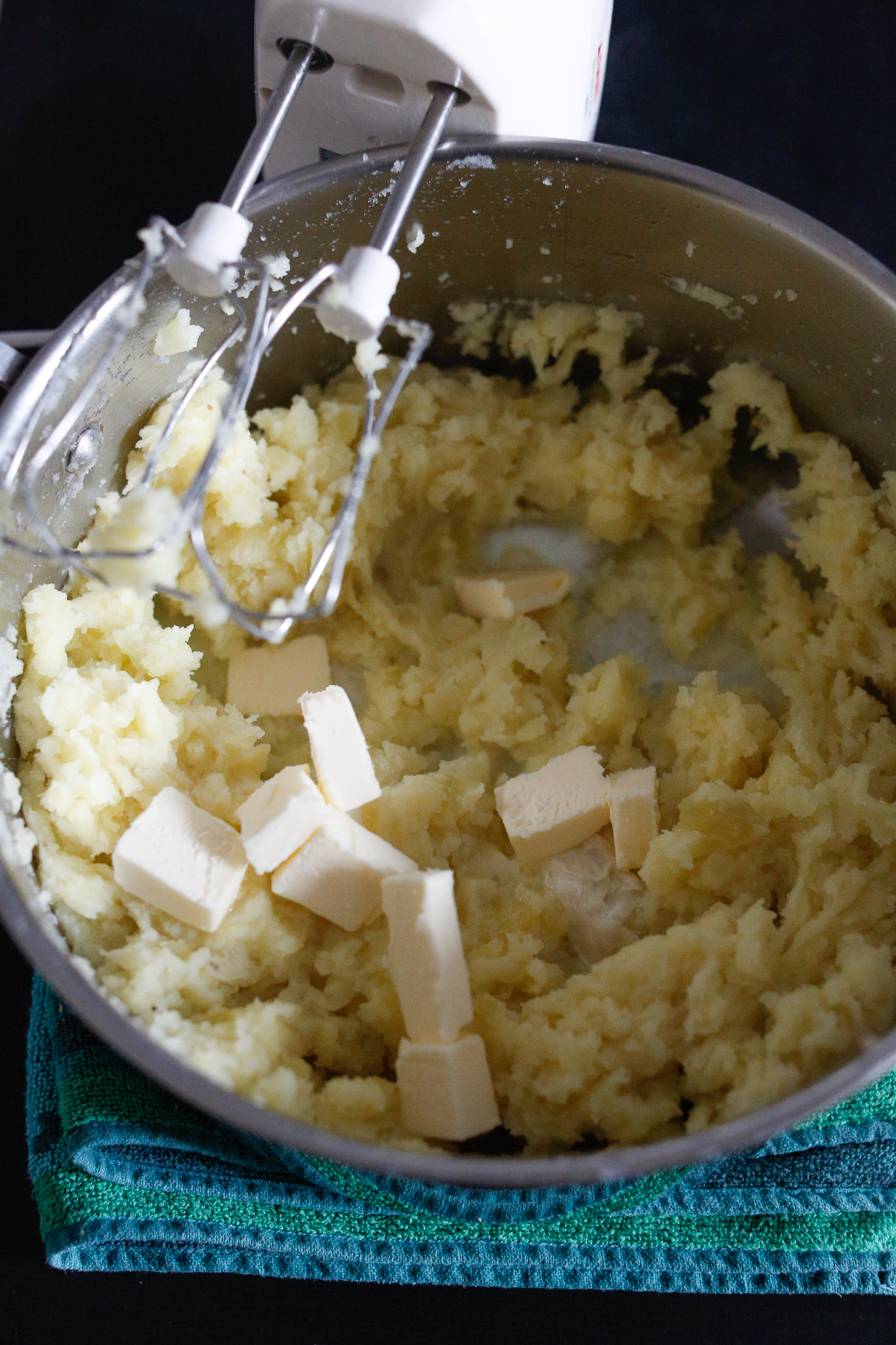 I like keeping the butter in cubes and allow it to melt slowly during the beating process