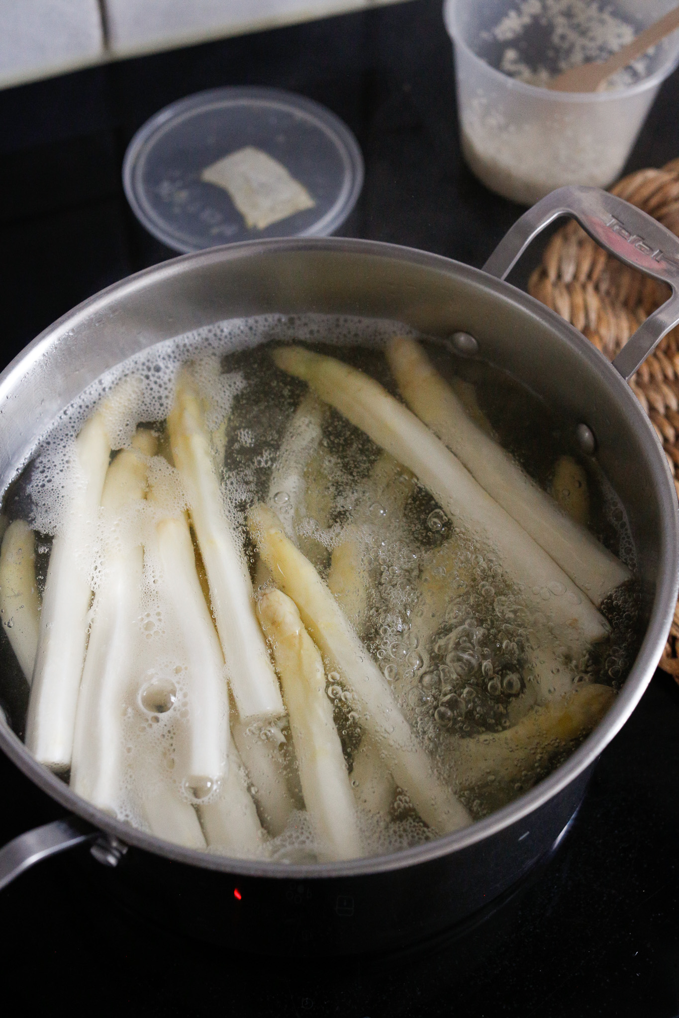 When you first add in your asparagus the temperature of the water will go way down and it will take a minute or two to come back to a boil