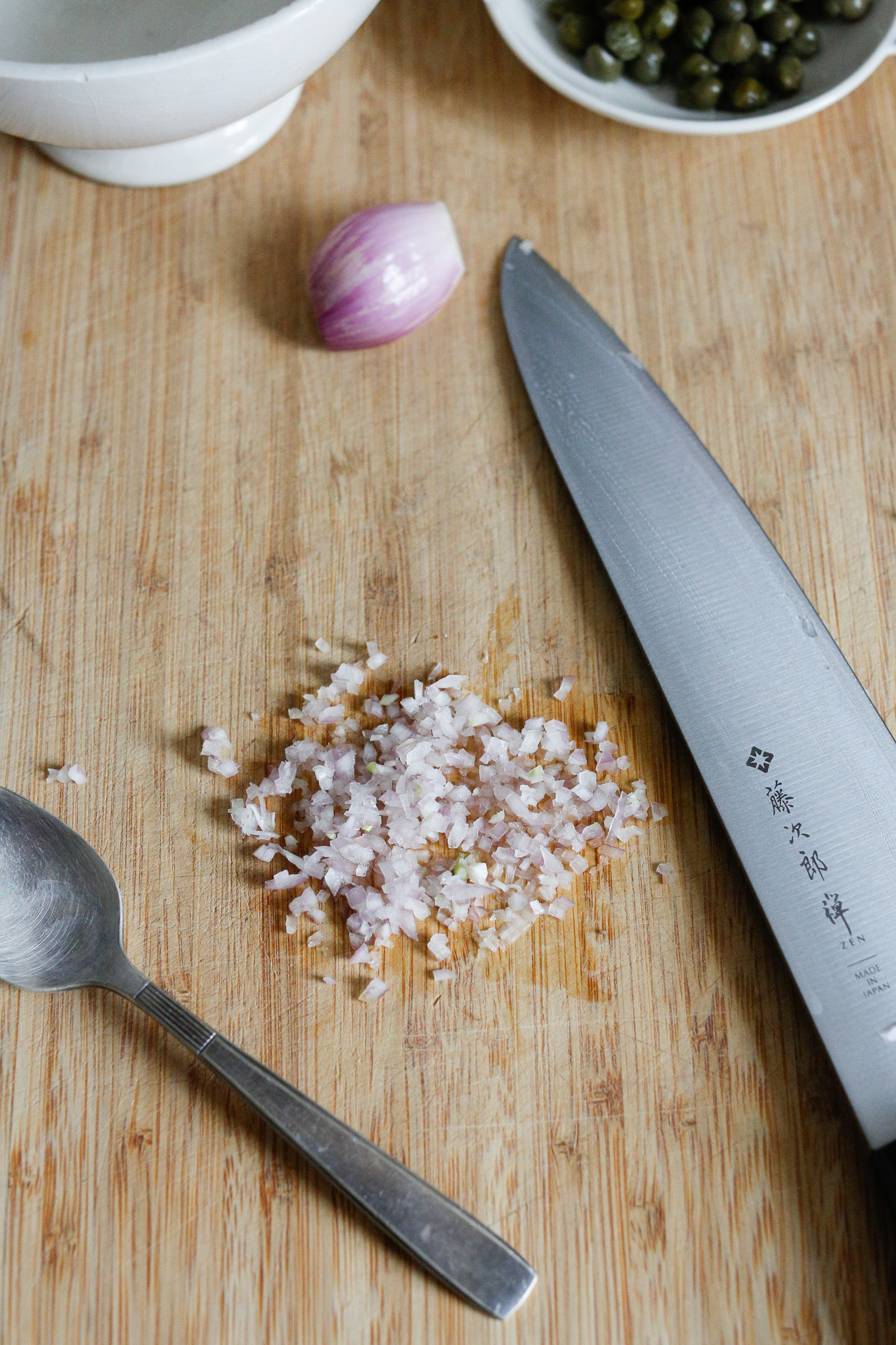 Start your vinaigrette by finely chopping up your shallots