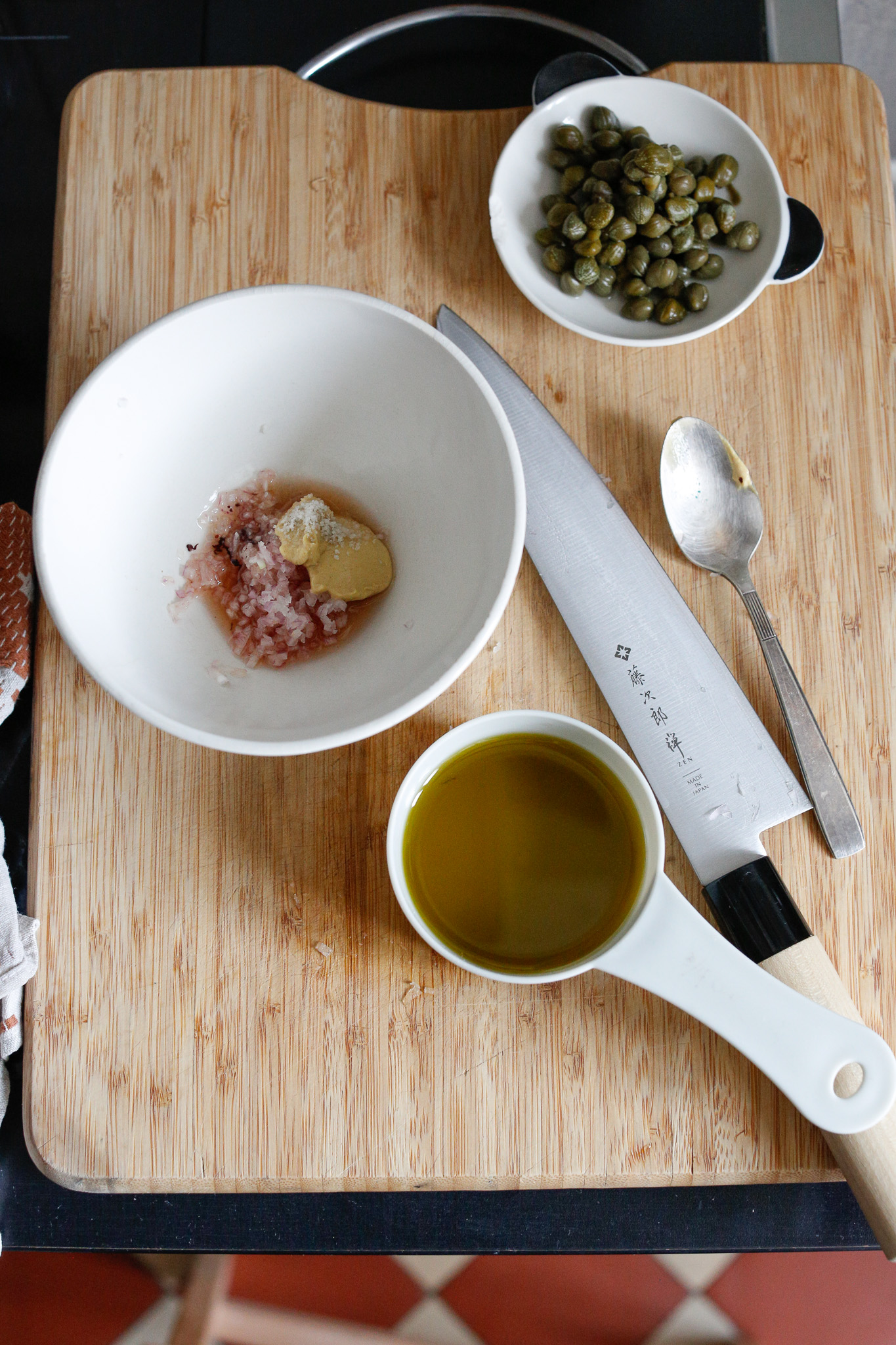 Even though it shows me adding in the shallots at this point, I wouldn't! First add in your olive oil, vinegar, mustard and salt. Mix that up and then add in the shallots
