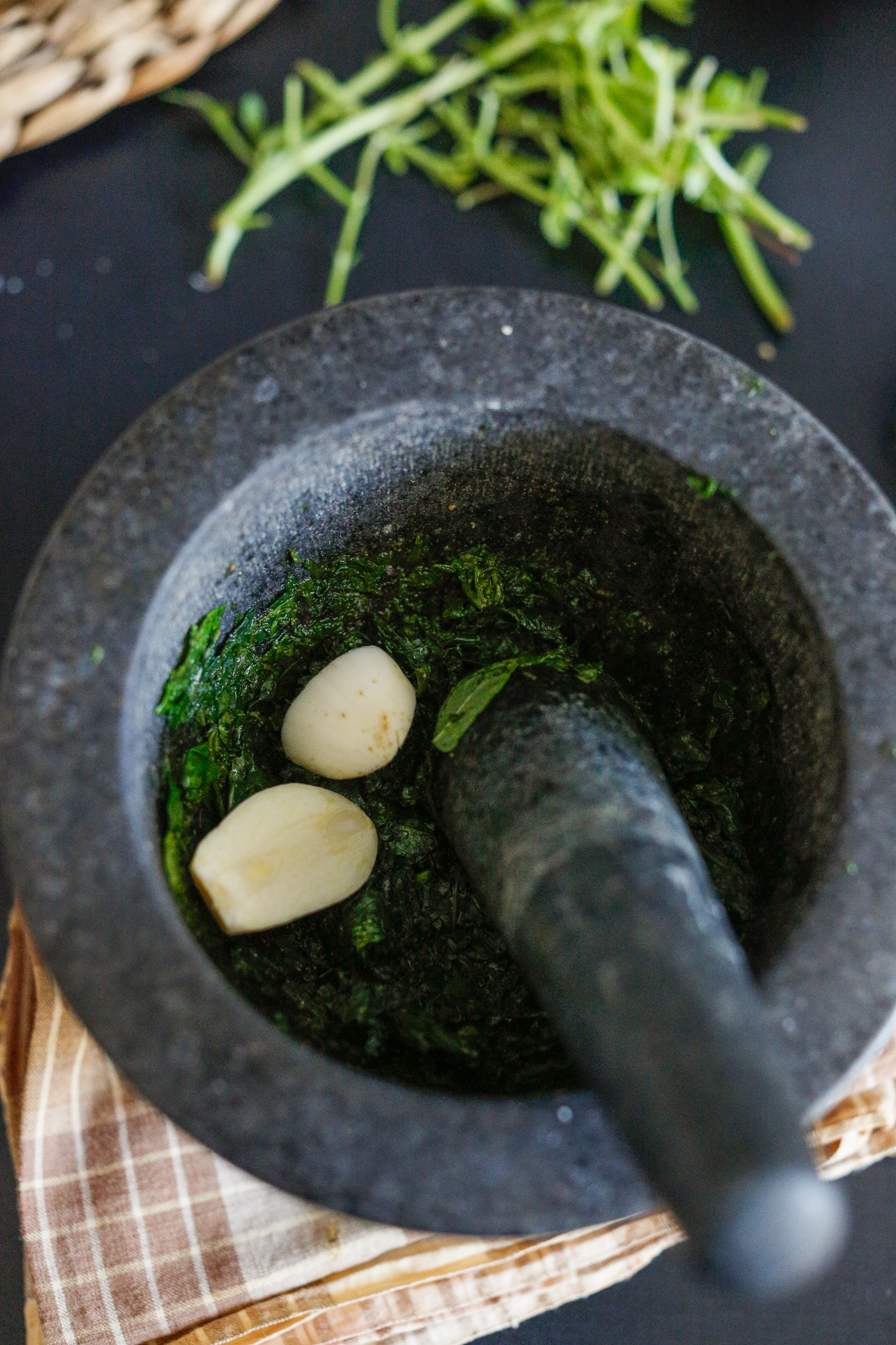 When you get your leaves to about this point, add in your garlic. This is one piece cut in half