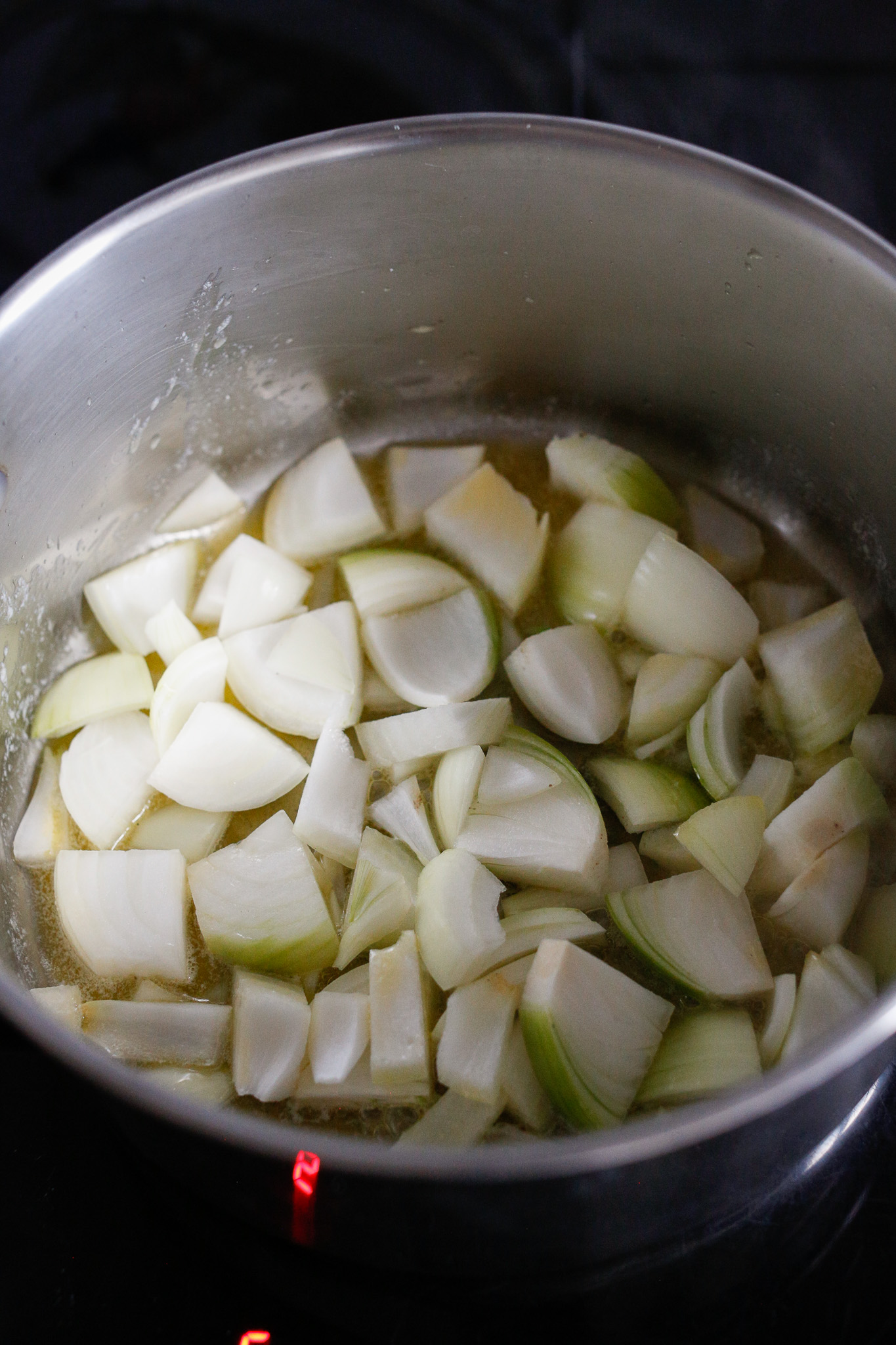 Roughly cut up your onions and add them to your melted butter for softening.