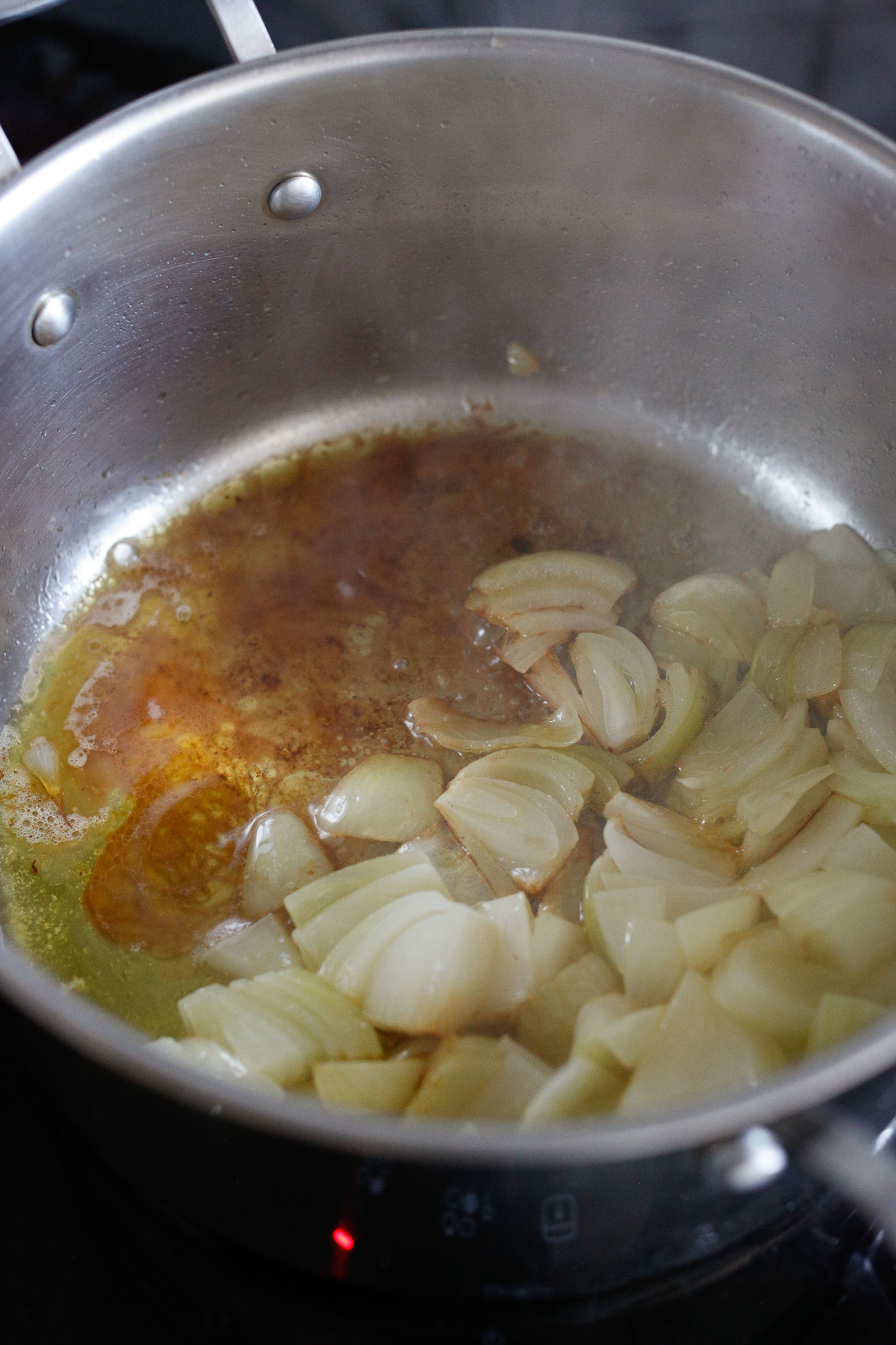 When your onions have browned, add in your vinegar. In this photo I have already added the vinegar and I scrape the bottom the pan with a wooden spatula to make sure any crust is incorporated.