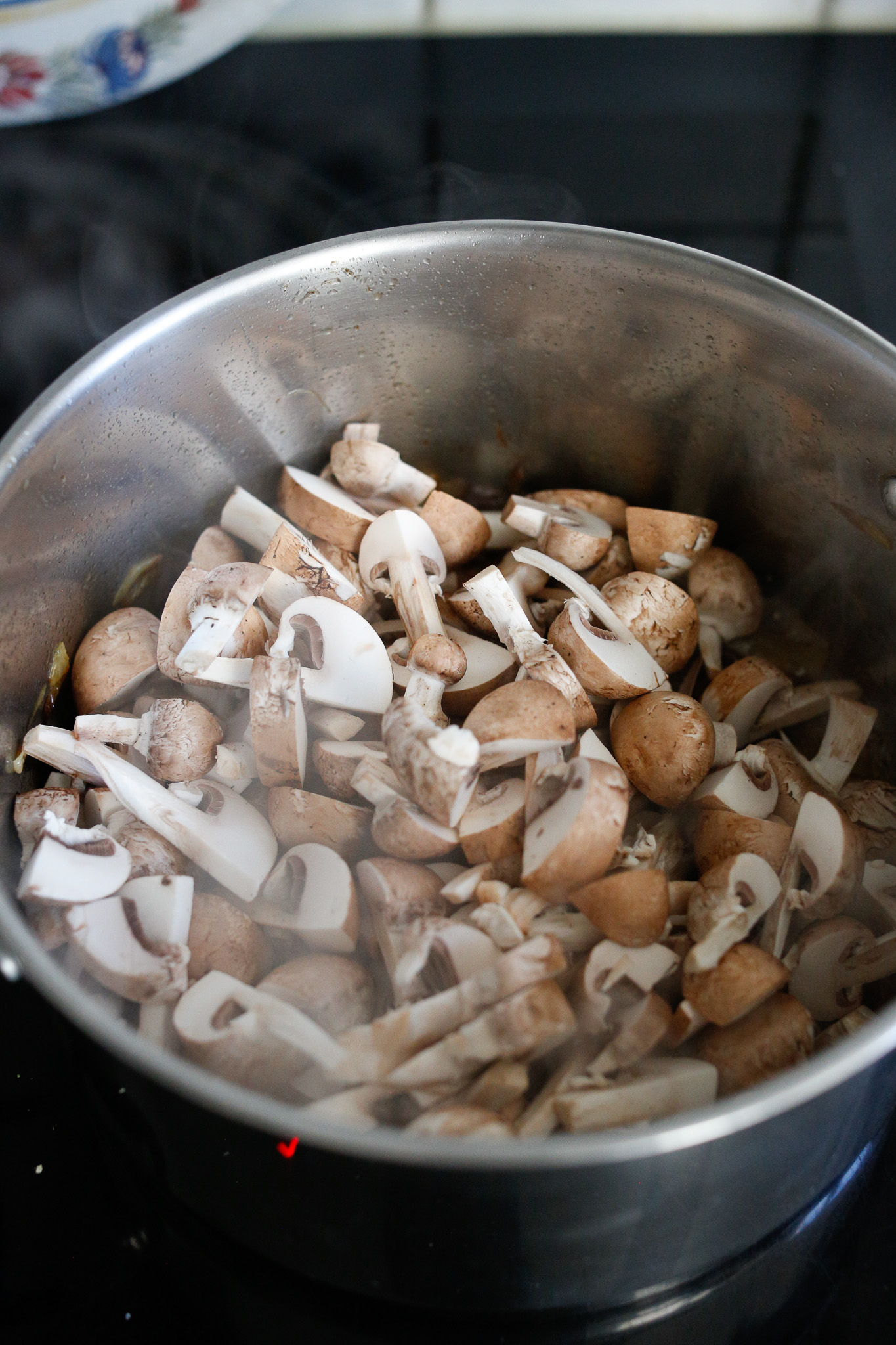Add your mushrooms and allow them to cook down a bit, you can do the lid trick again to speed up the process. Once they cook a bit, add your cognac and flambee.