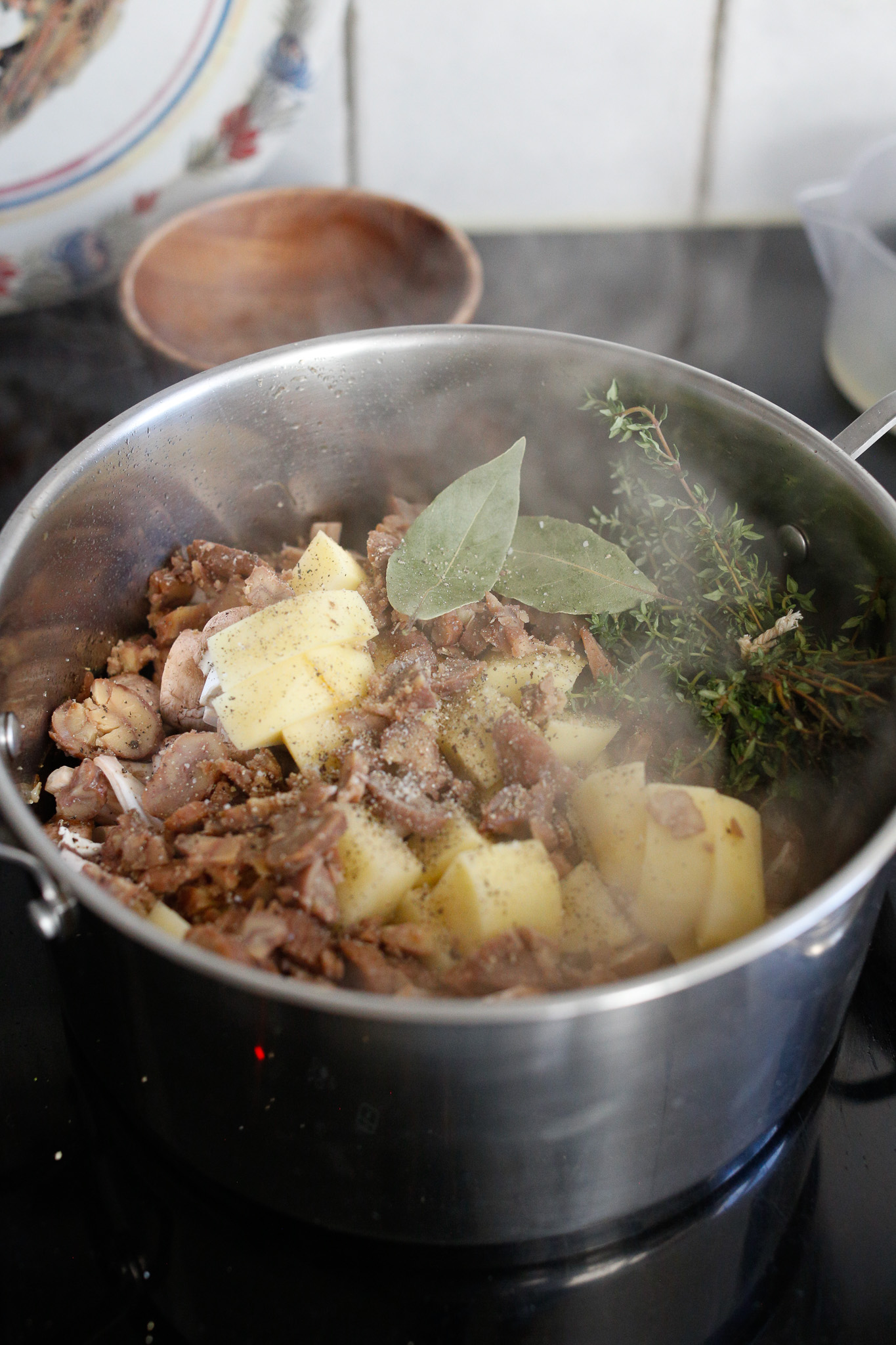 After flambeeing, add in your potatoes, thyme, bay leaves, chestnuts and remaining mushrooms.