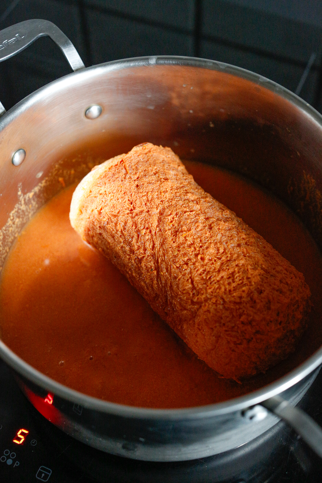 Once it's defrosted enough, slip it out into your soup pot and cover with a lid. Warm on medium low for about 20-30 until it's completely defrosted