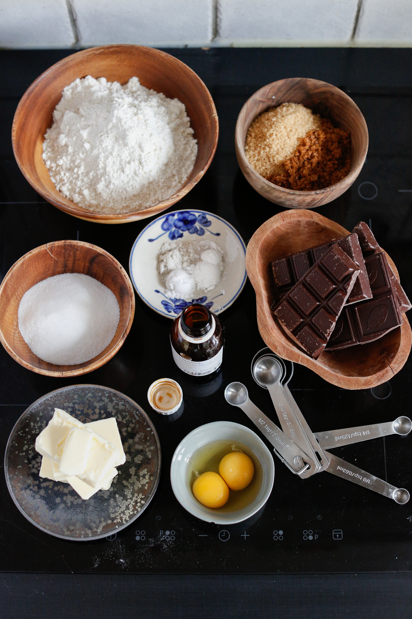 Flour, baking soda, salt, white sugar, light brown sugar, dark brown sugar, butter, vanilla extract, eggs, dark chocolate, maldon salt