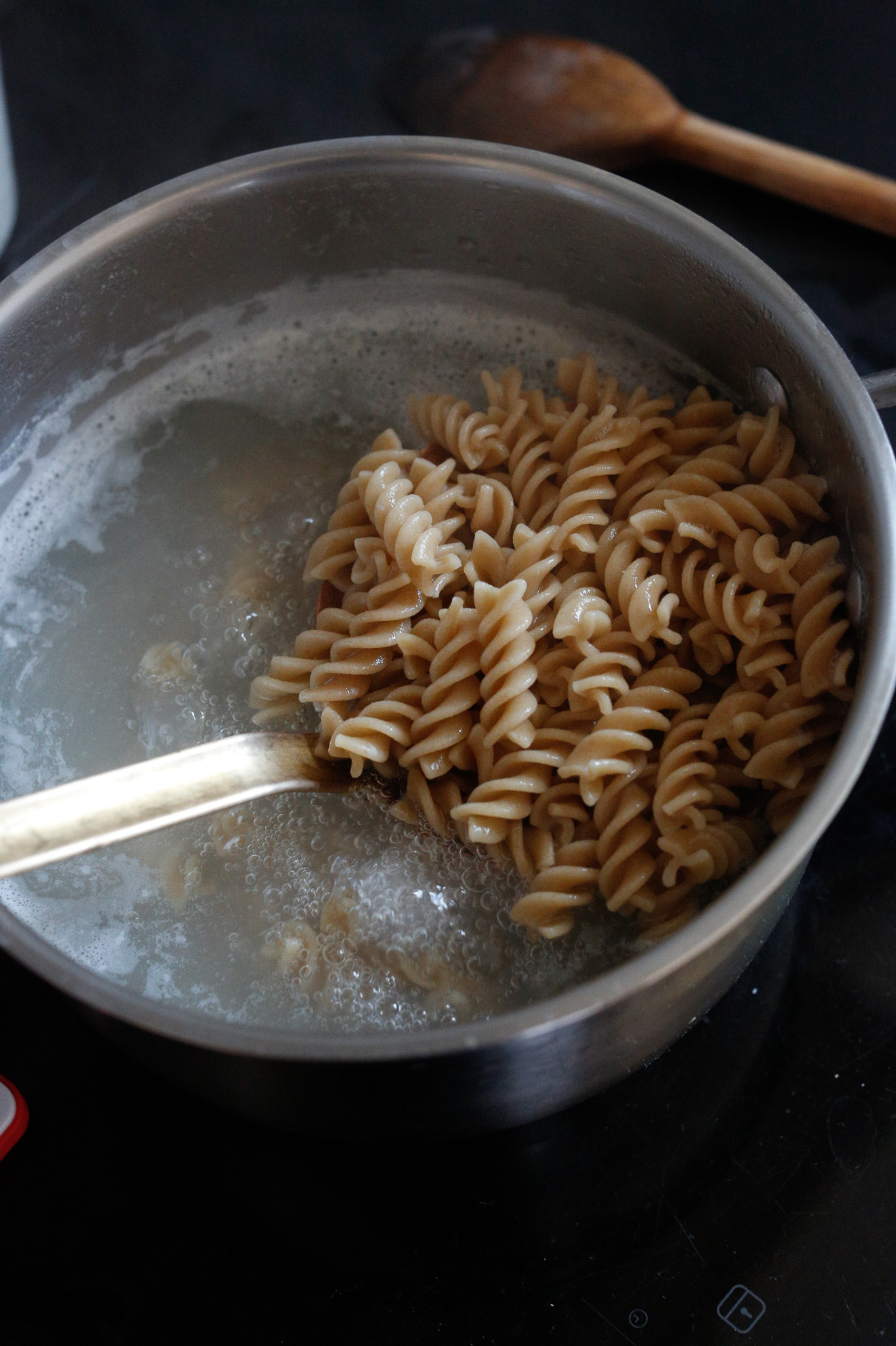 If you pull out your pasta like so and put it in your ice bath, you can reuse the same water to cook your green beans.
