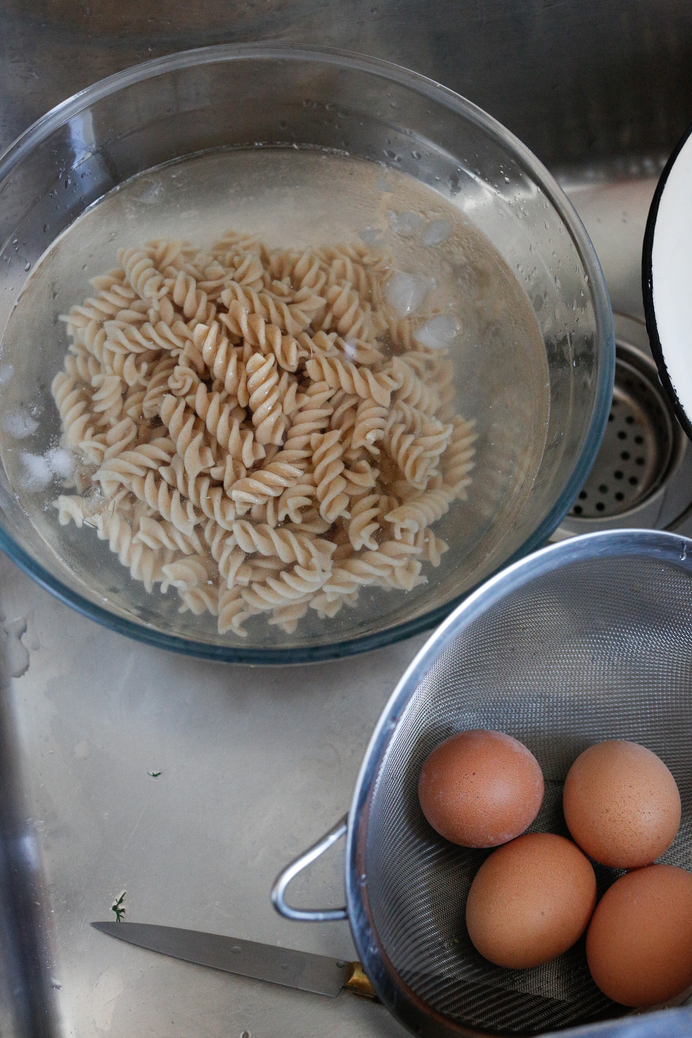 Allow your pasta to cool slightly in your ice bath and then transfer them to a colander to drip dry.