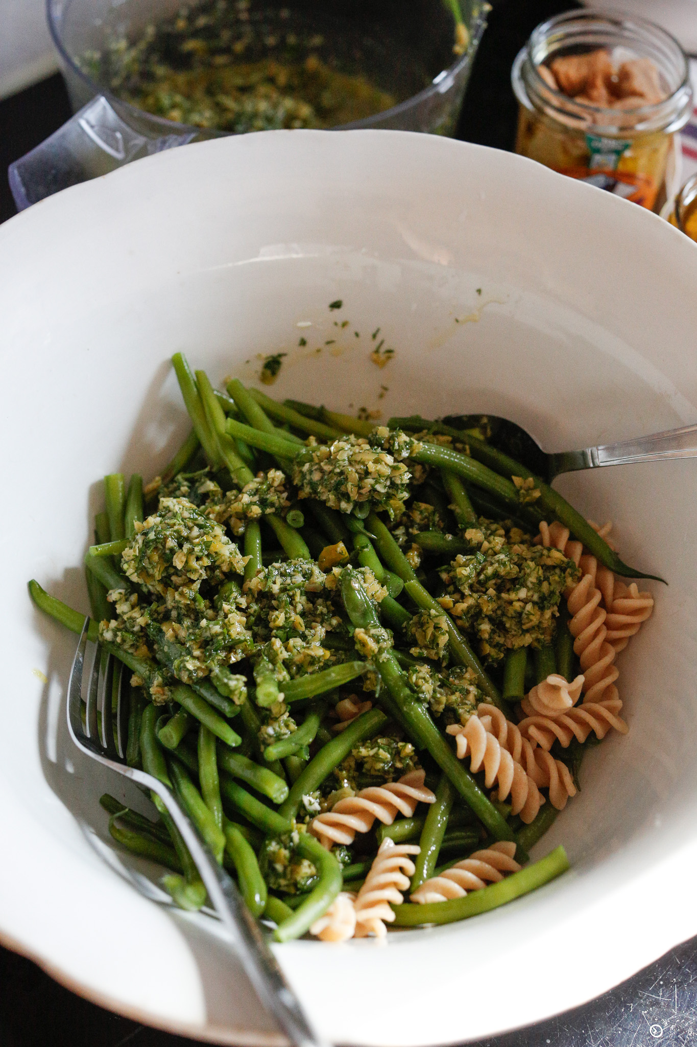 I like to start by layoring in my green beans, pasta, dressing and then mixing.