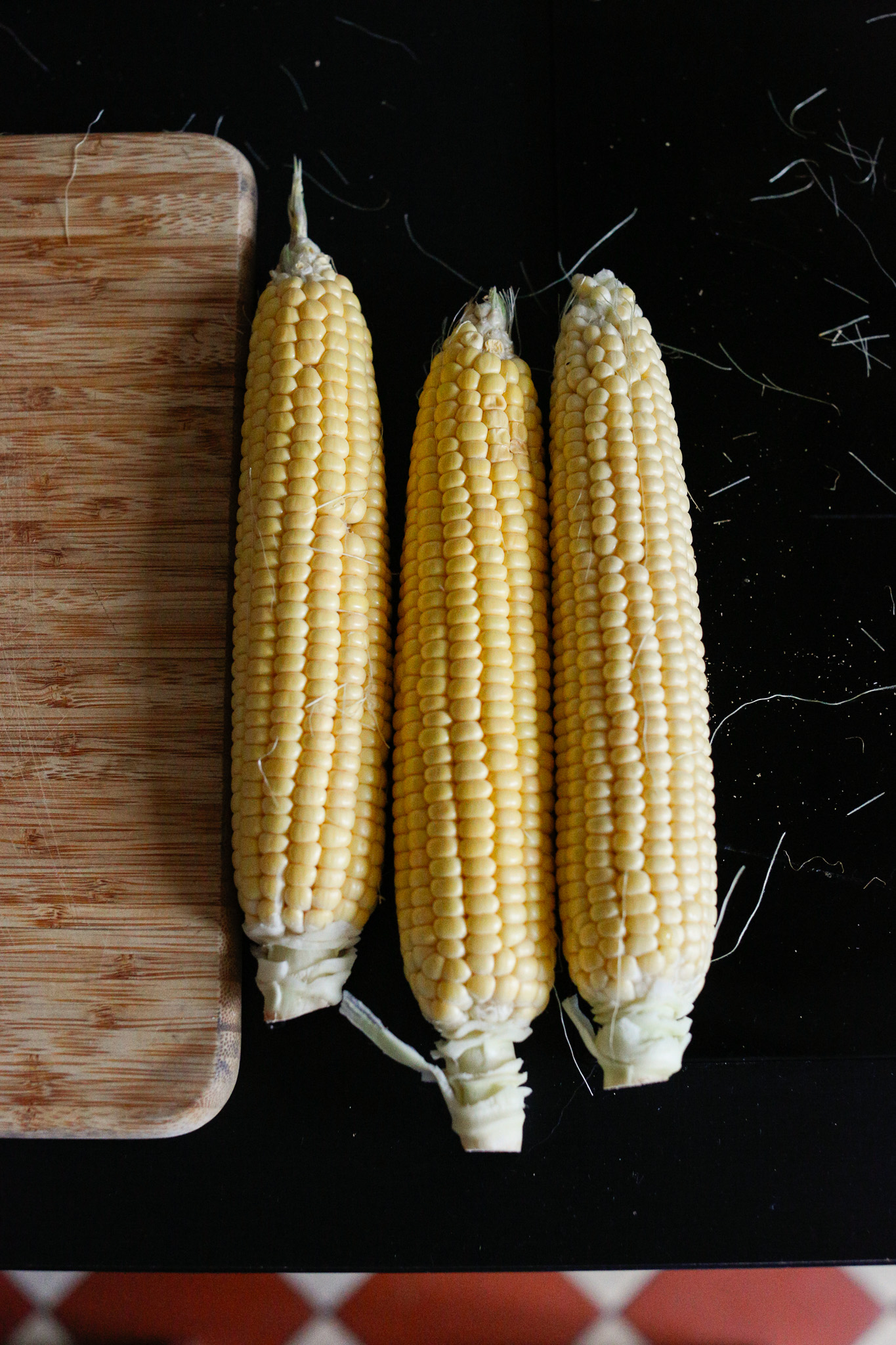 Shuck your corn husks and do your best to get off all the silky fibers.