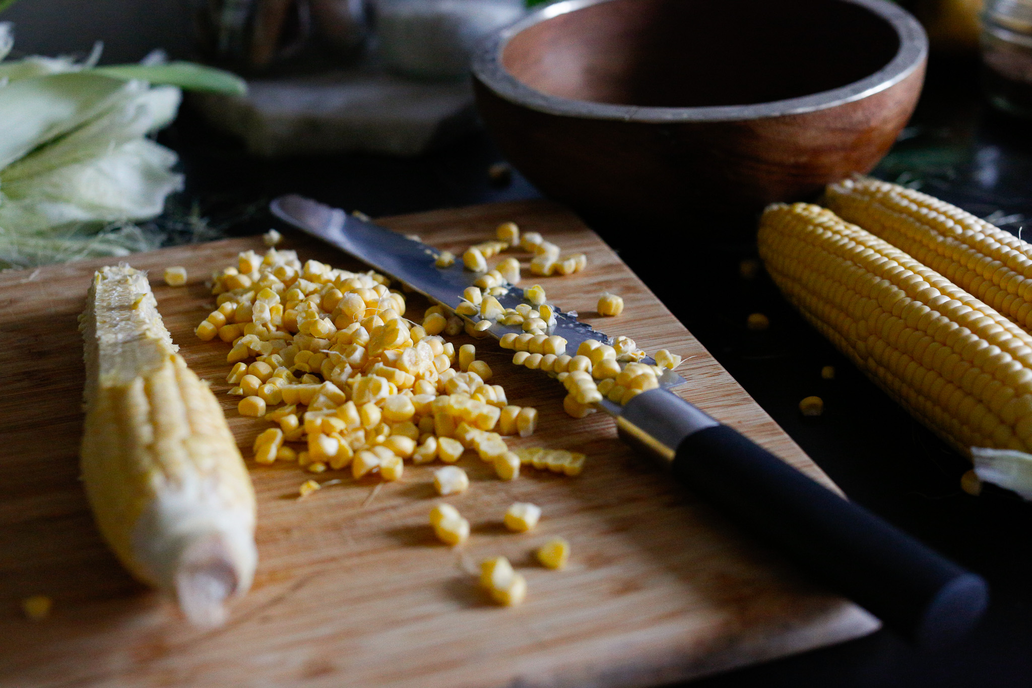 Cut corn off the husk in preparation for your chowder