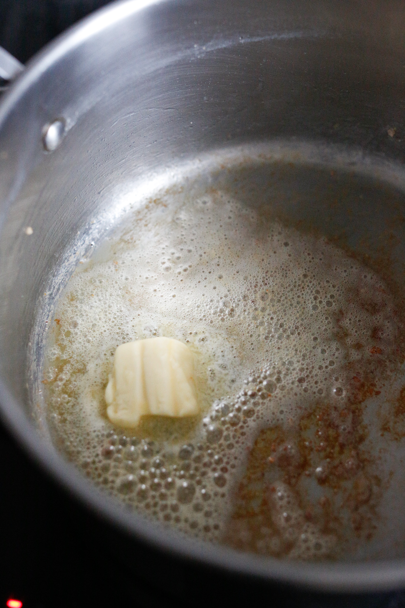 Add your butter and allow to melt while scraping any browned bits leftover from the pancetta with a wooden spatula.