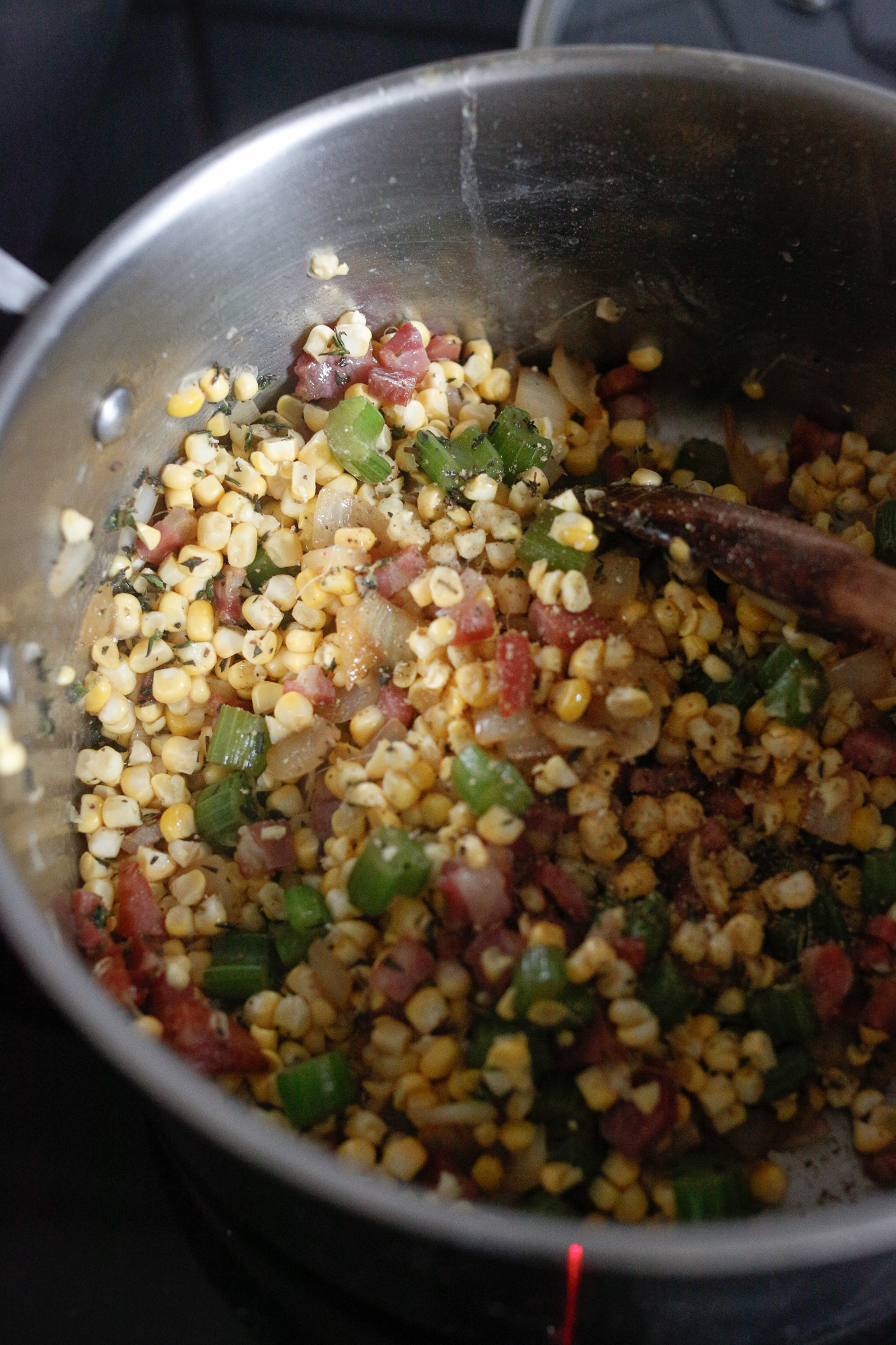 Once your onions & celery are transulenct, add back in your pancetta along withthe corn.