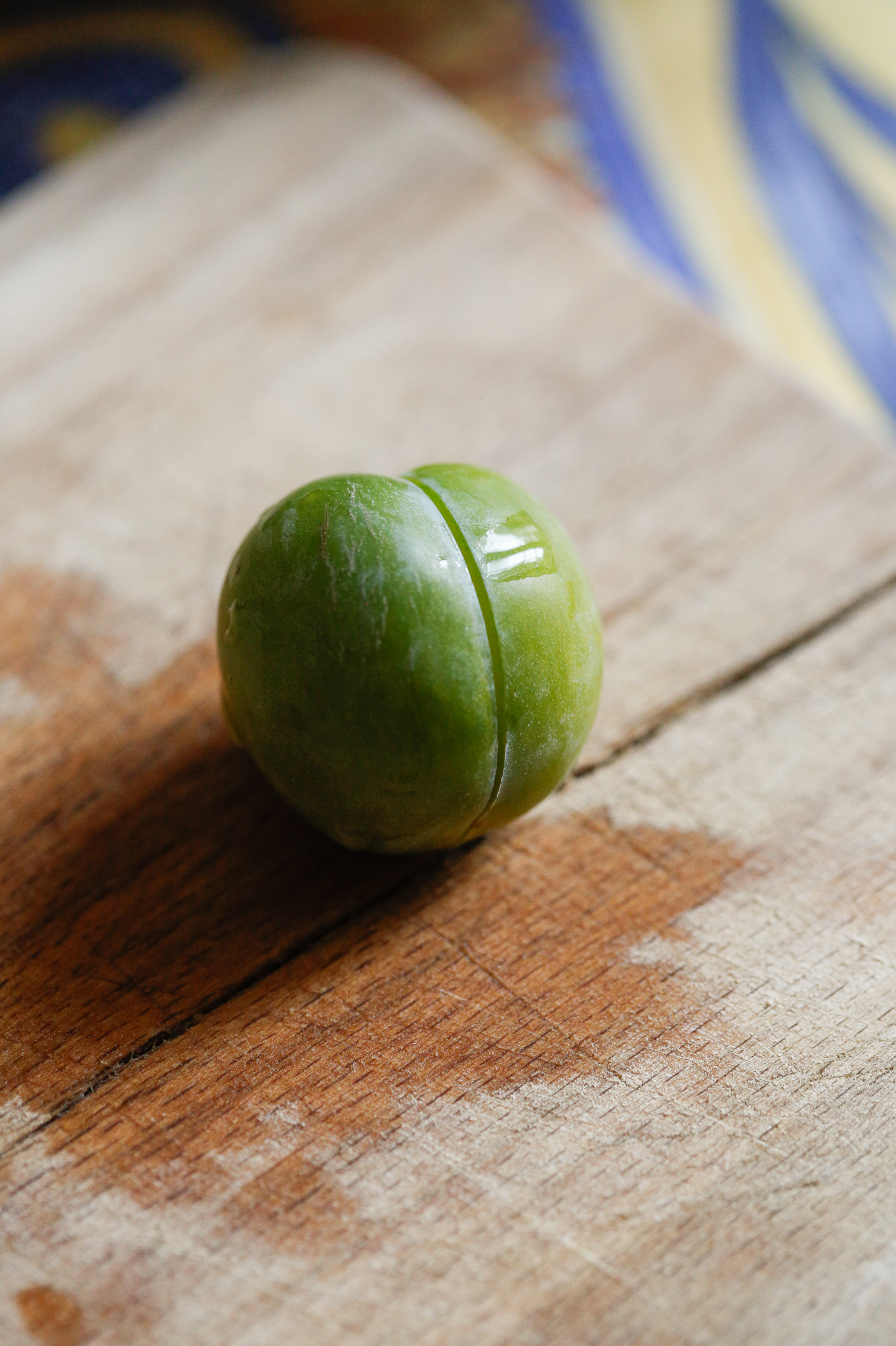 Meanwhile prepare your fruit. Start by de pitting your plums. Find the seam and cut down it all the way around the plum.