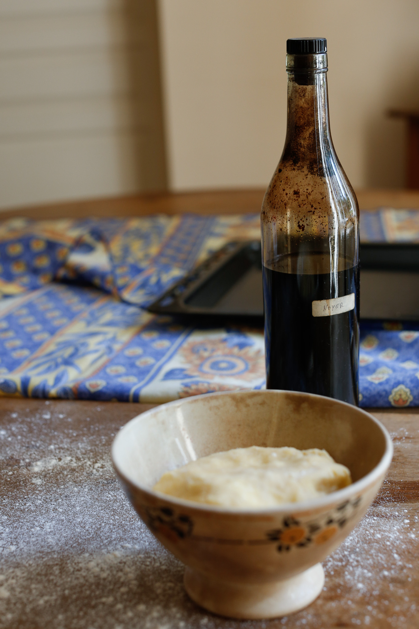 Prepare your work station for rolling out your dough. I didn't have a rolling pin so I found a super old bottle with homemade walnut liquor made. Most likely 4-60 years old by now!