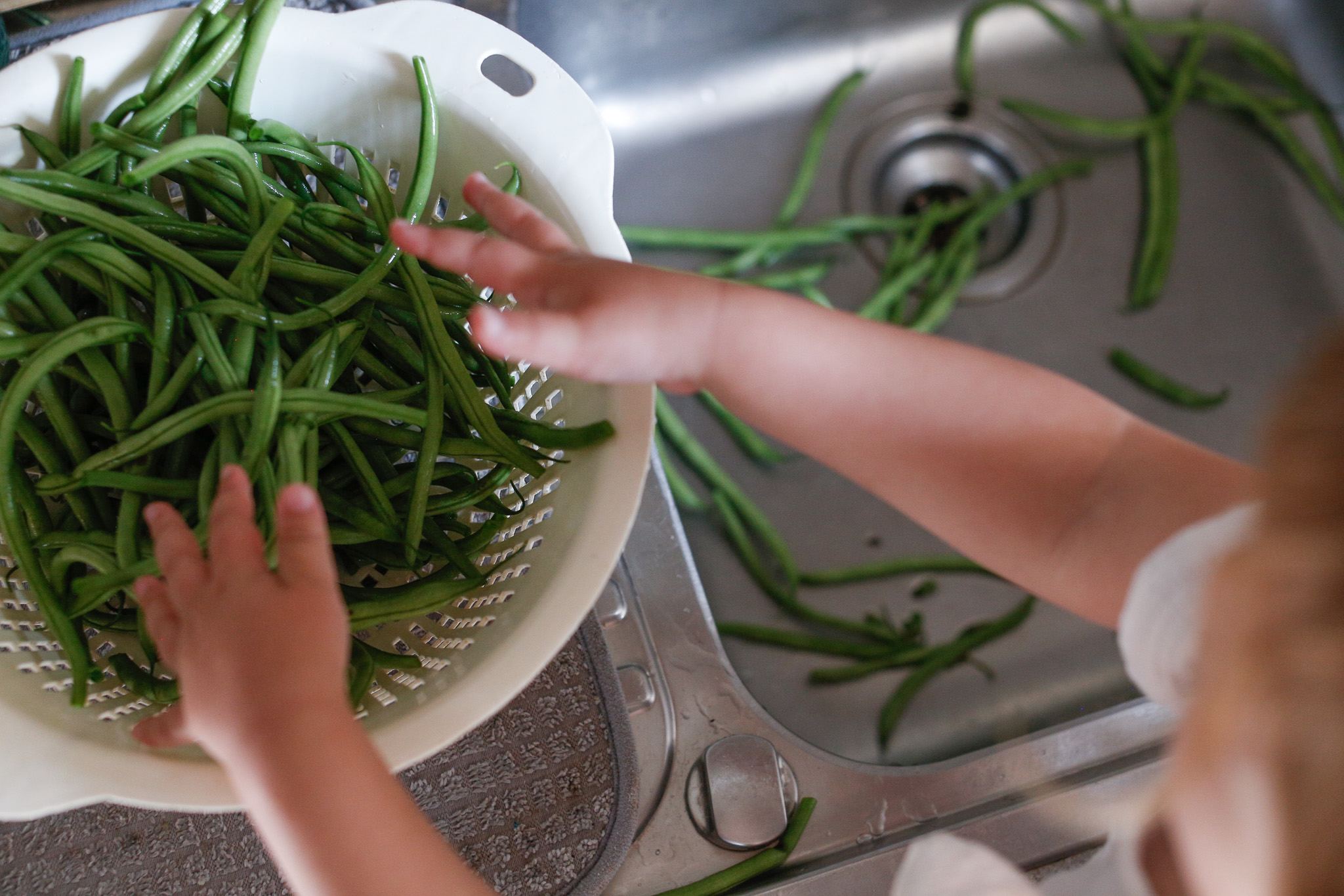 Eventually she found her way to transfer the beans from the bowl of water to the collander.