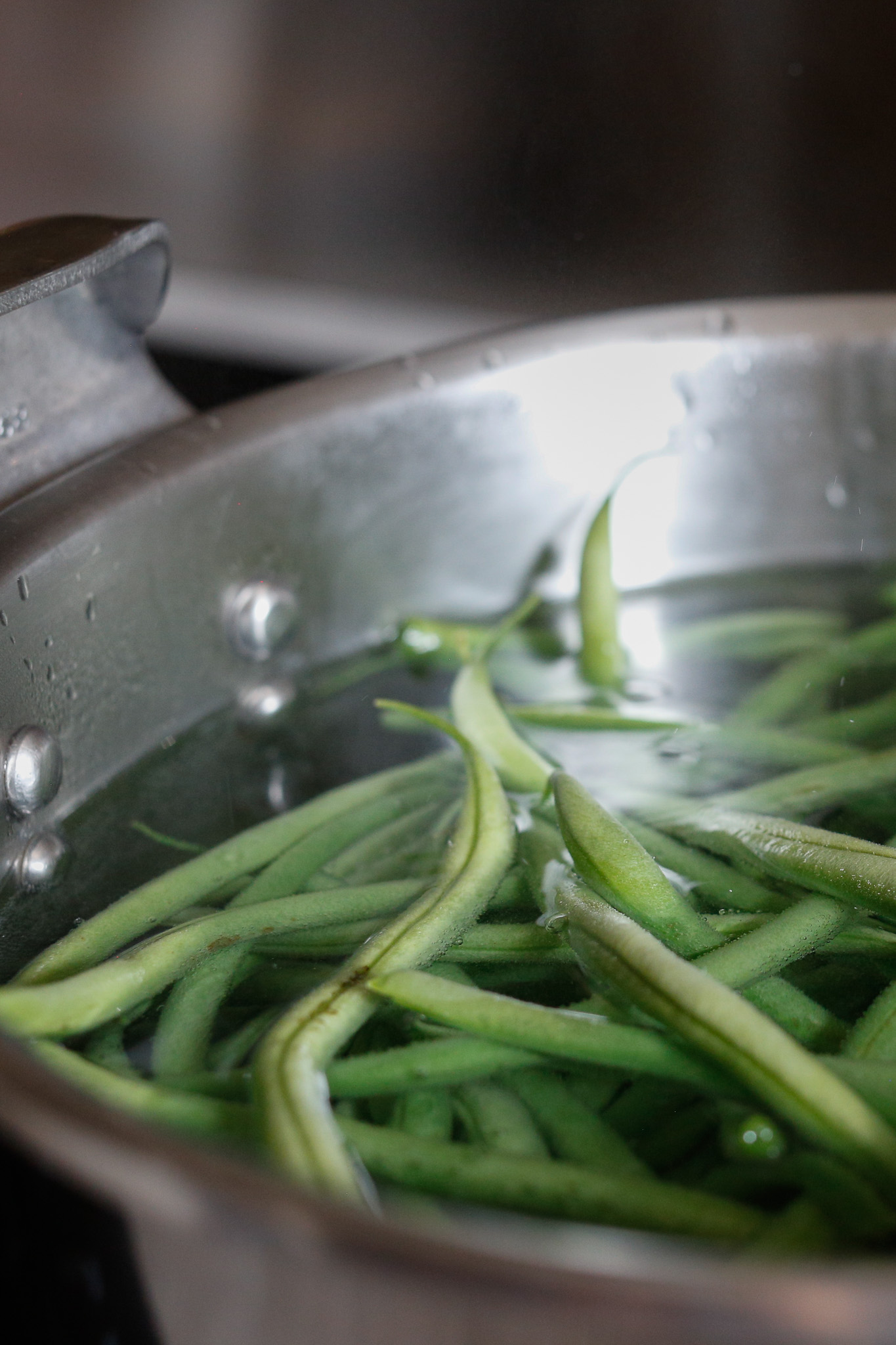 In order for my daughter to dump the beans into the big pot of water to cook, I keep the water cold and bring it to a boil after. Add salt too.