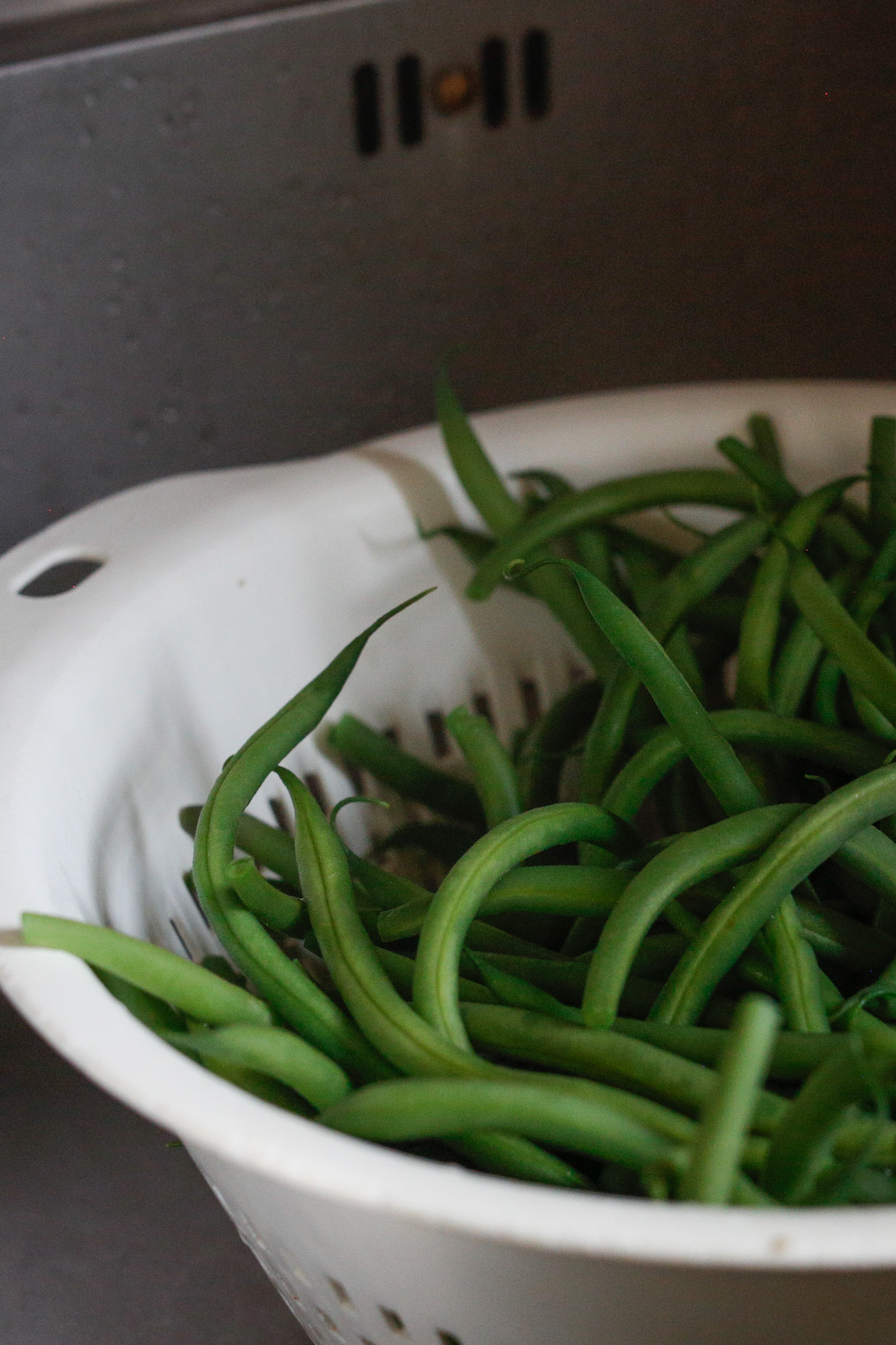 At this point you take over. You can invite your toddler to watch mindfully as you pour the hot beans & water into the collander. Or perhaps they have lost interest by this time and that is ok too.