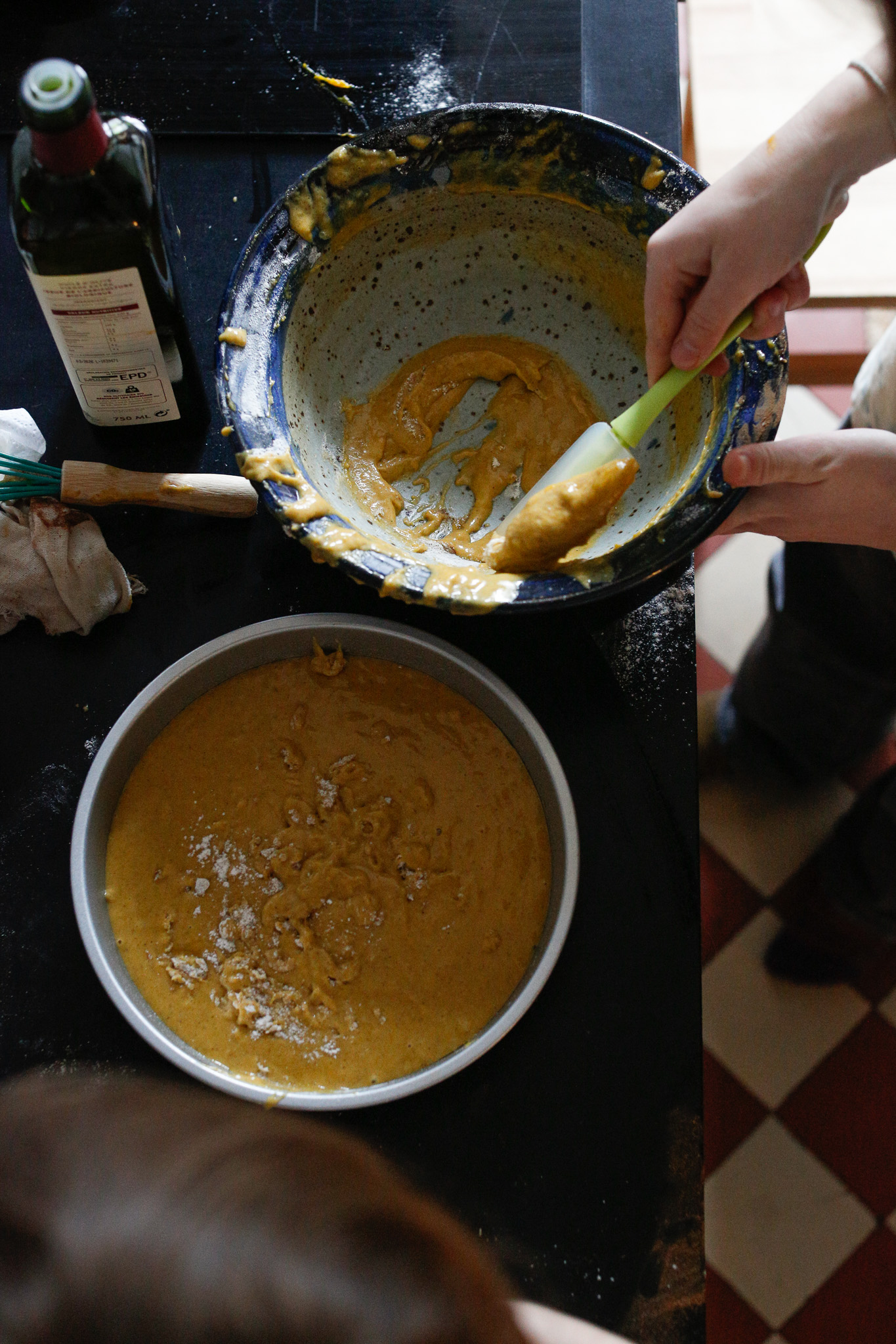 Uncle Alex finishes the job making sure all the batter gets in and also showing Q the magic of a rubber spatula.