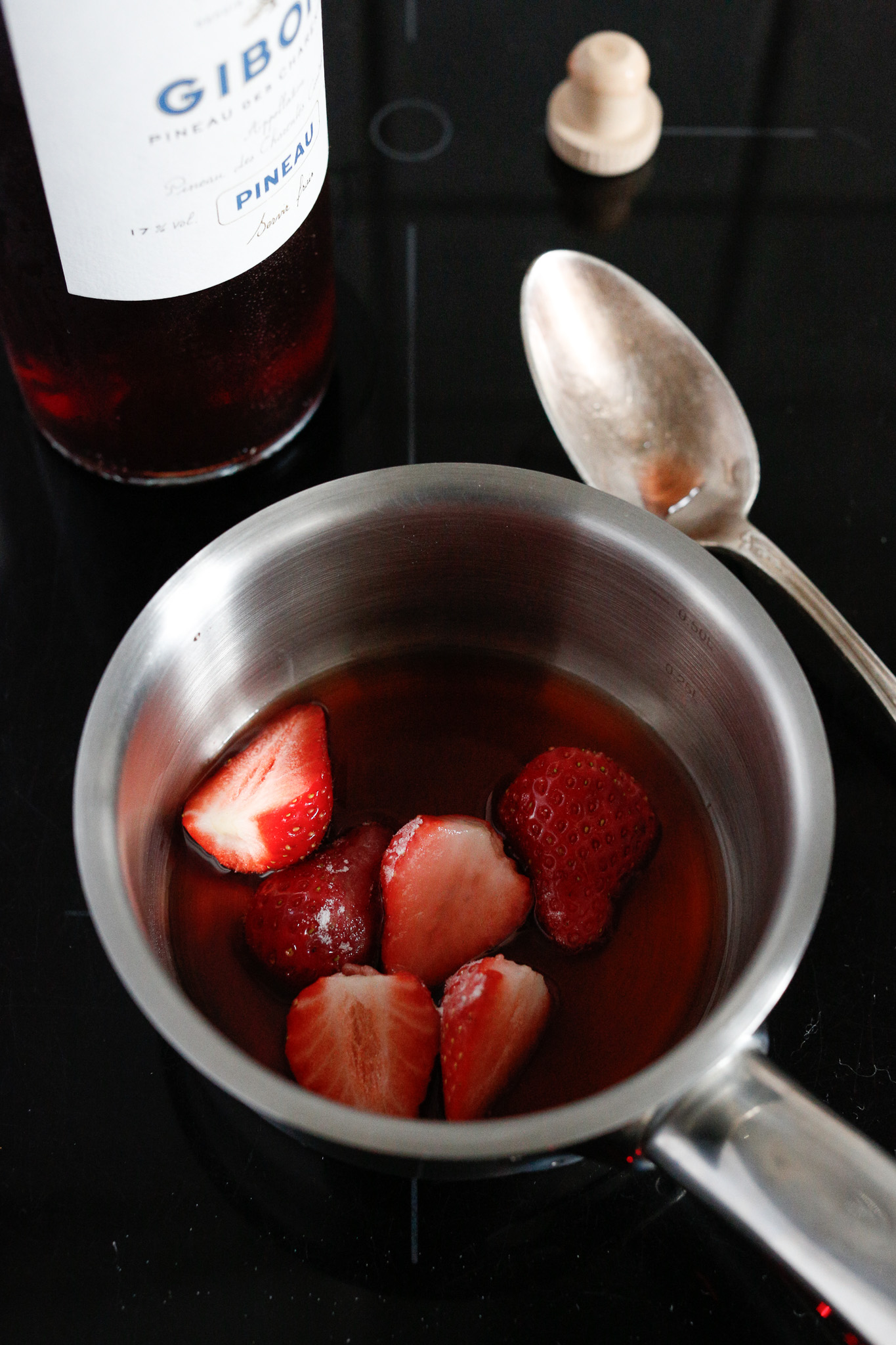 In a small saucepan add your 3 strawberries, Pineau des Charentes (or Porto,) sugar and water and bring to a boil.