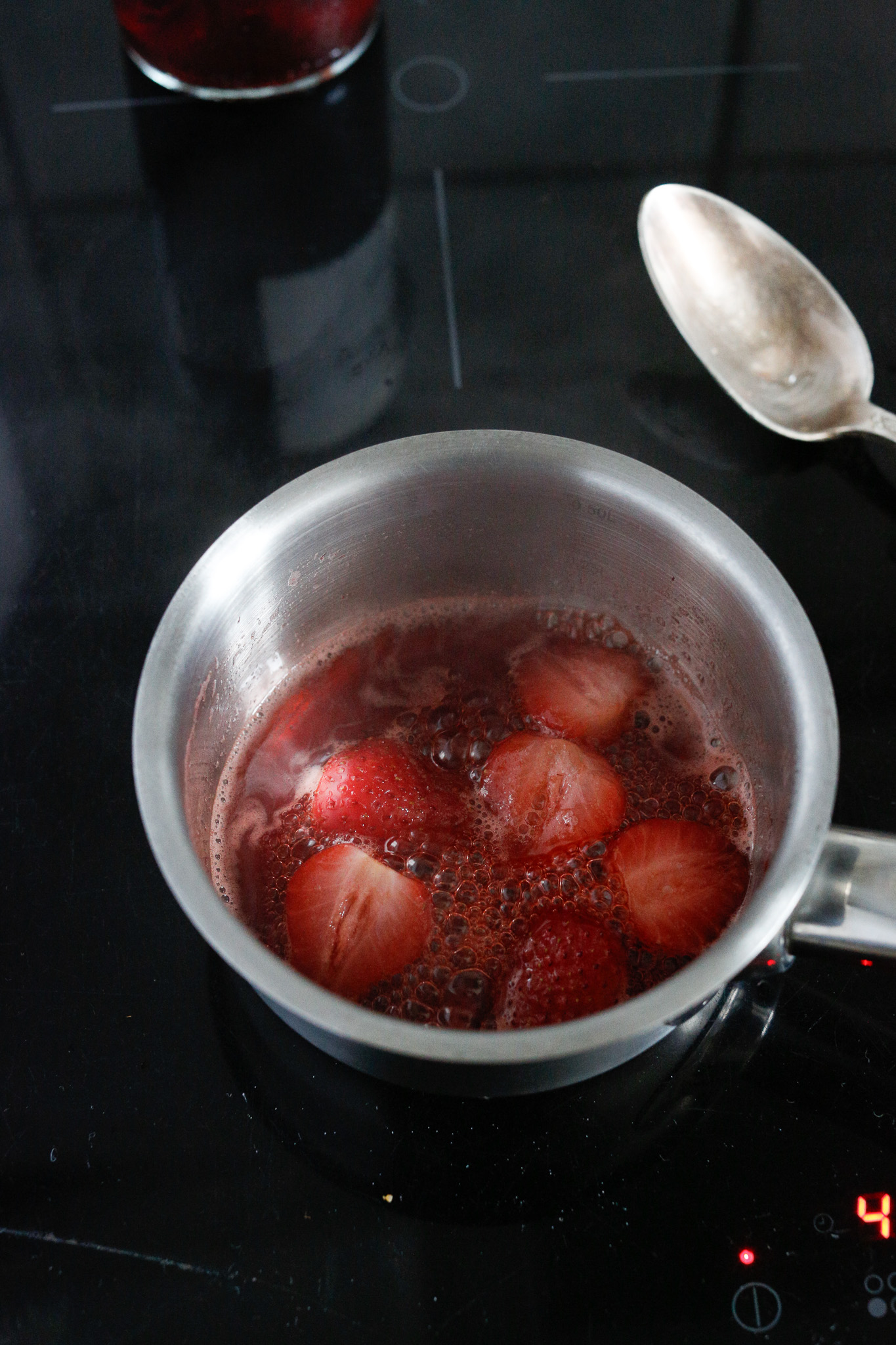 Let the strawberries simmer until the sauce starts to thicken and takes on a syrupy consistency.