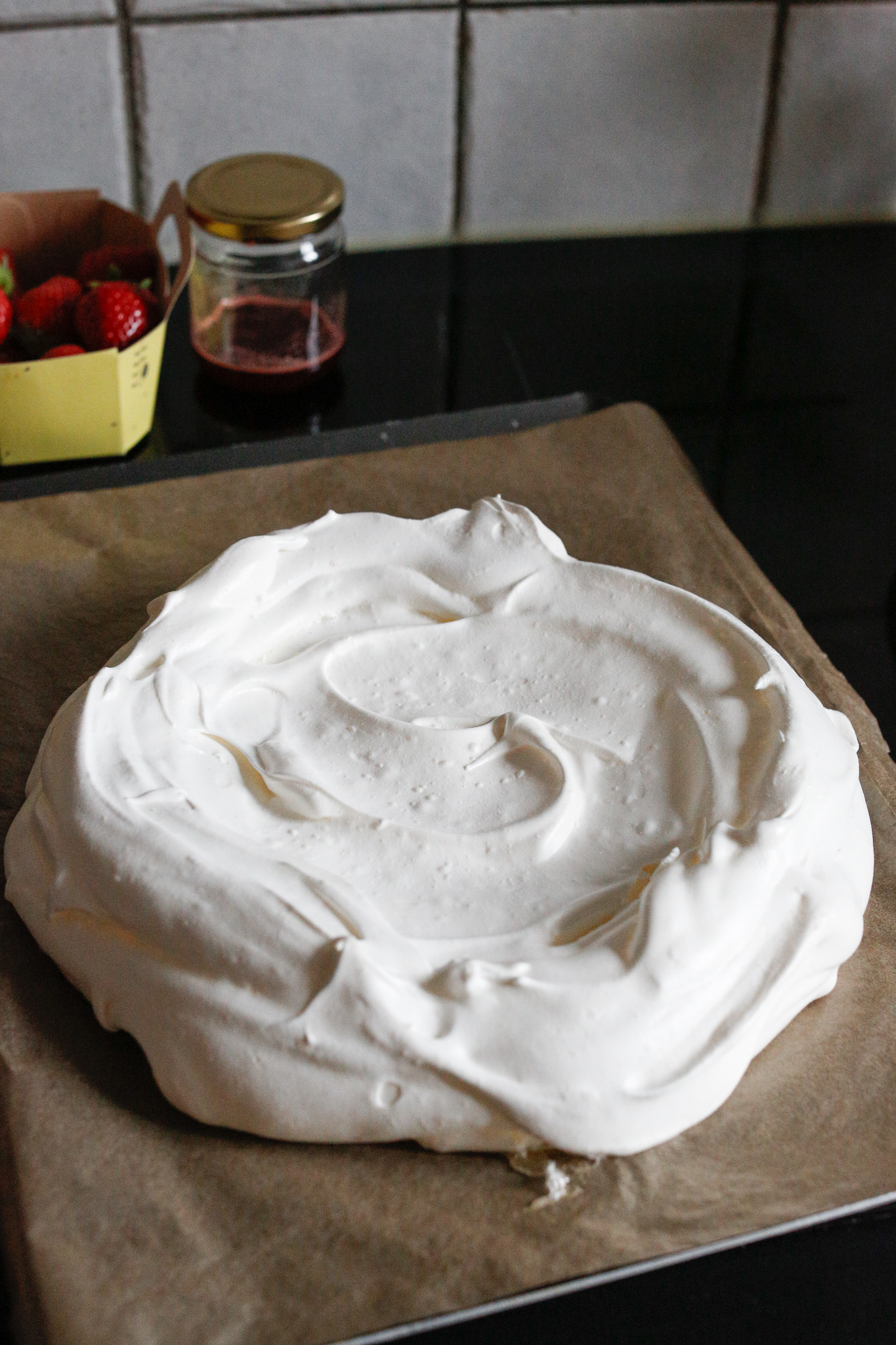 Once it has cooled in the oven go ahead and take it out. Ideally you will be able to mindfully lift it from the parchment paper and transfer it to your flat cake plate but sometimes it cracks too much for this.