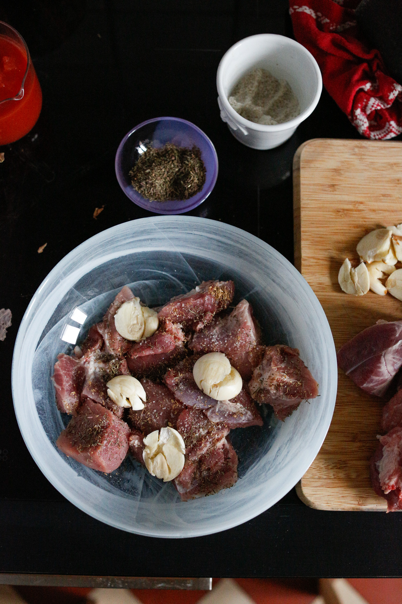 Salt each piece front to back and then cover them with herbs. Lay the garlic on top.