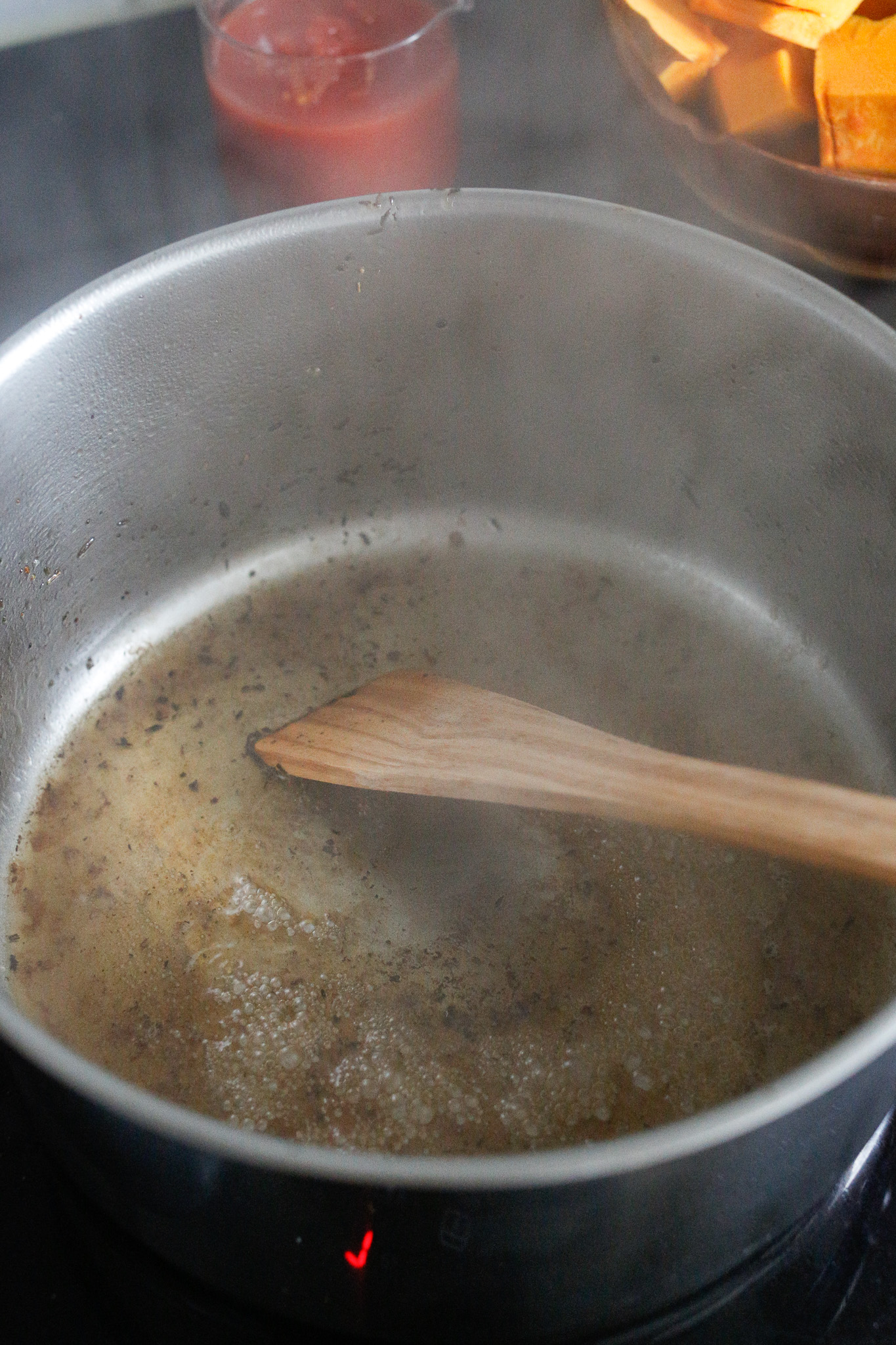 Pour about 1/4 cup of water in the pot and use your wooden spoon to scrape it off.