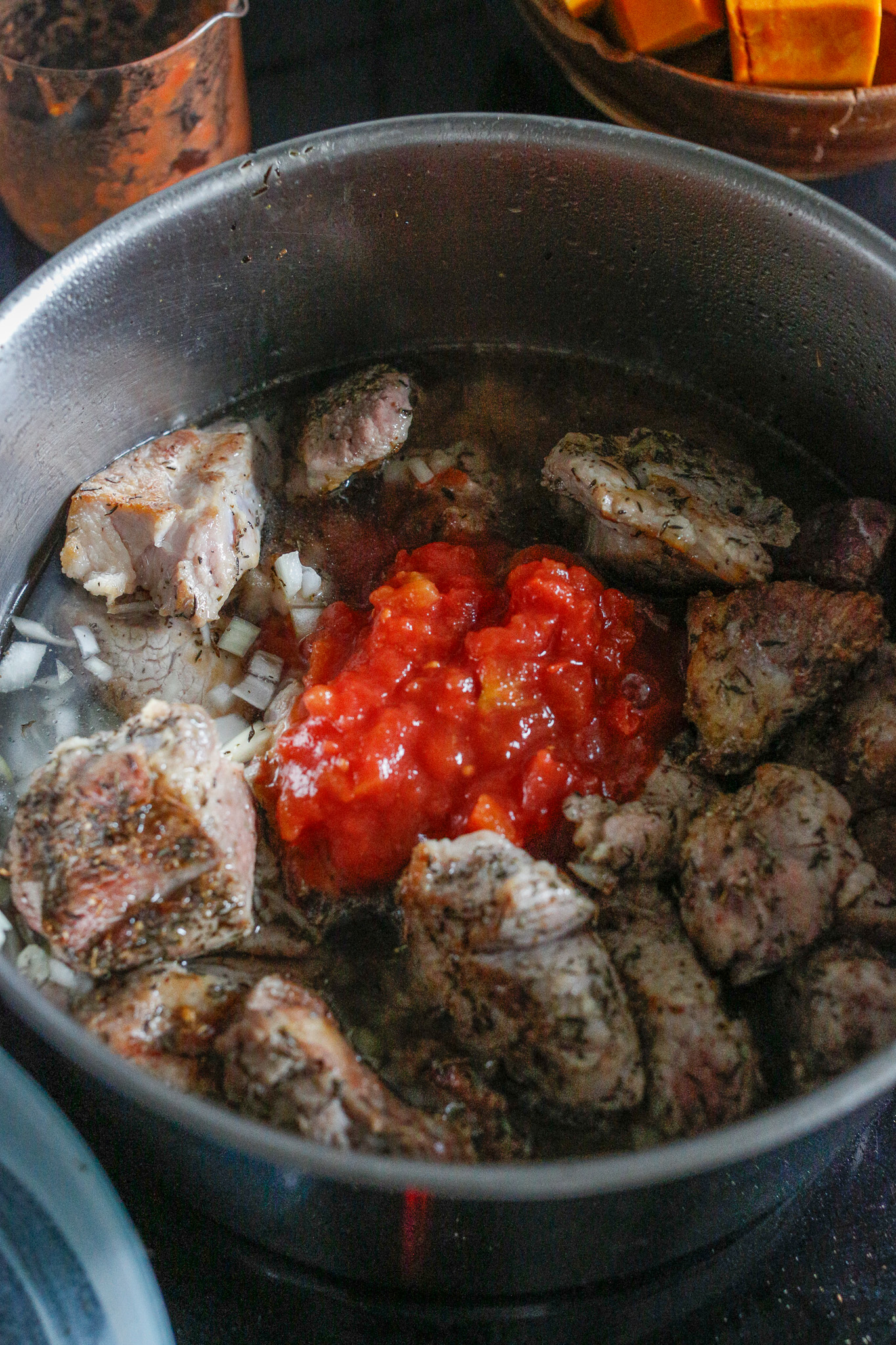 Add back in your browned pieces of meat & tomatoe puree.