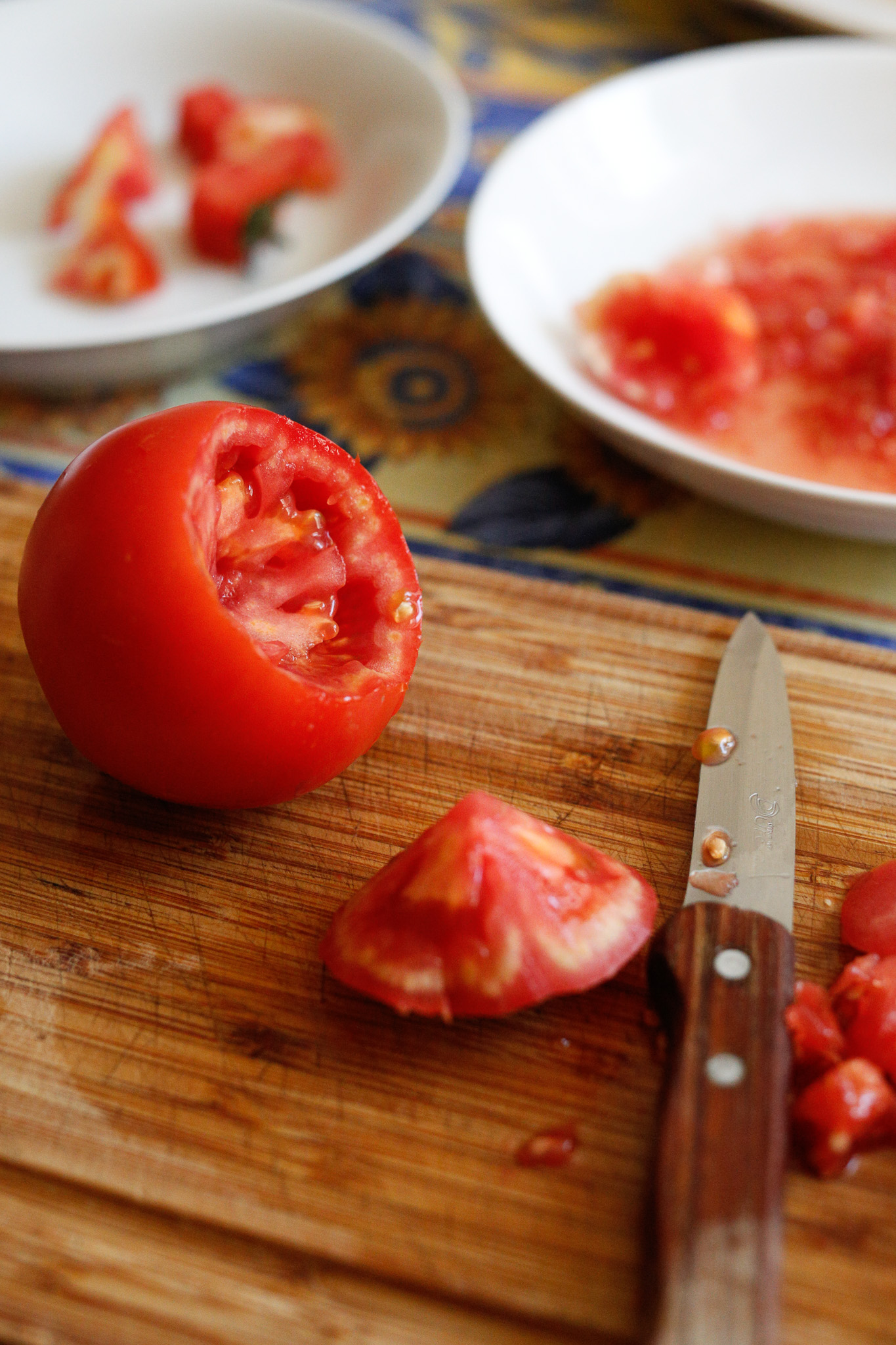 Start by cutting around the top of the tomato to create a whole for your stuffing to go in. You want your hole to approxiamately take up 1/3 of the tomato.