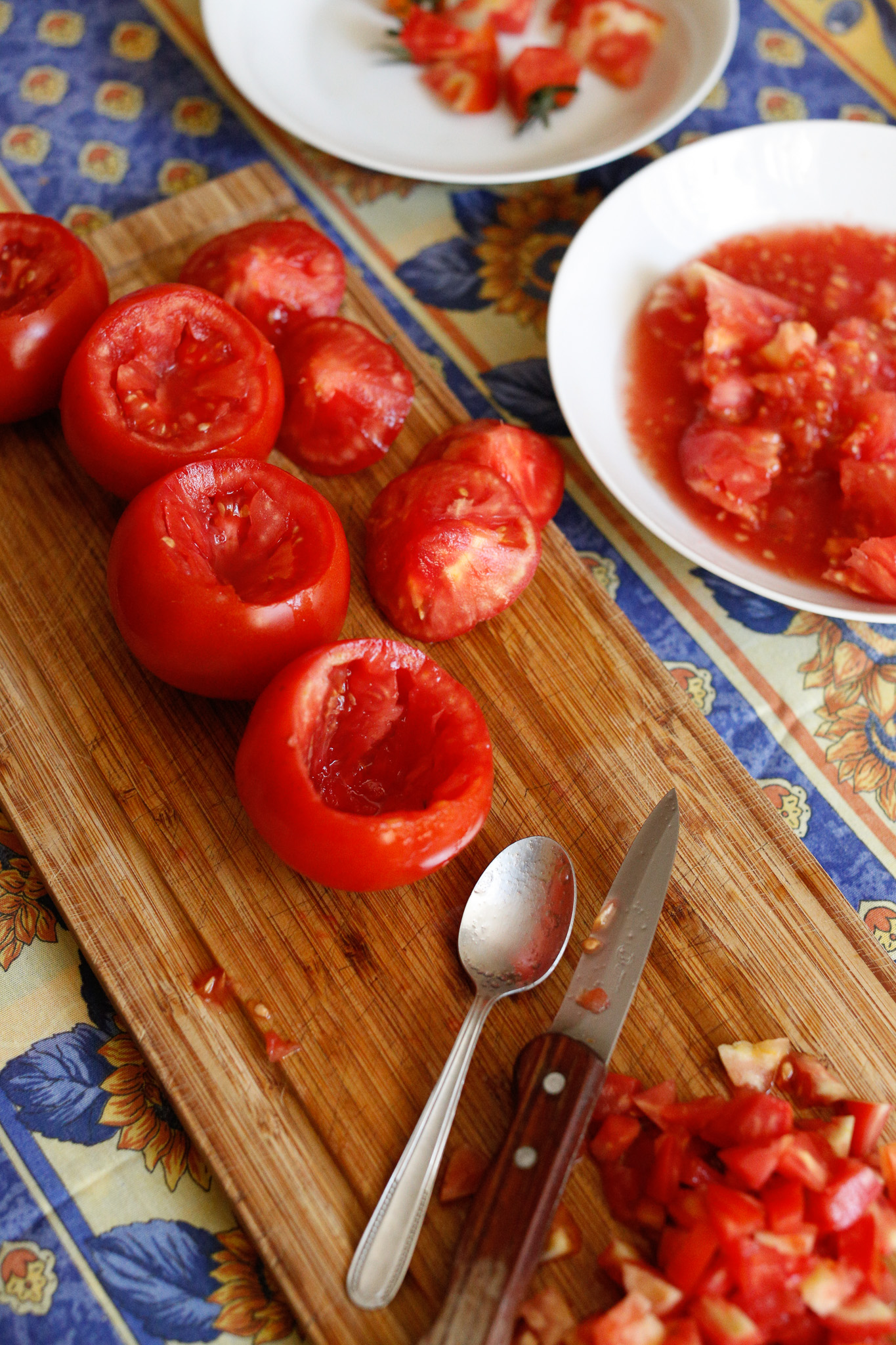 Use your knife to cut around the inside of the tomato to make it easier to dig out with a spoon.