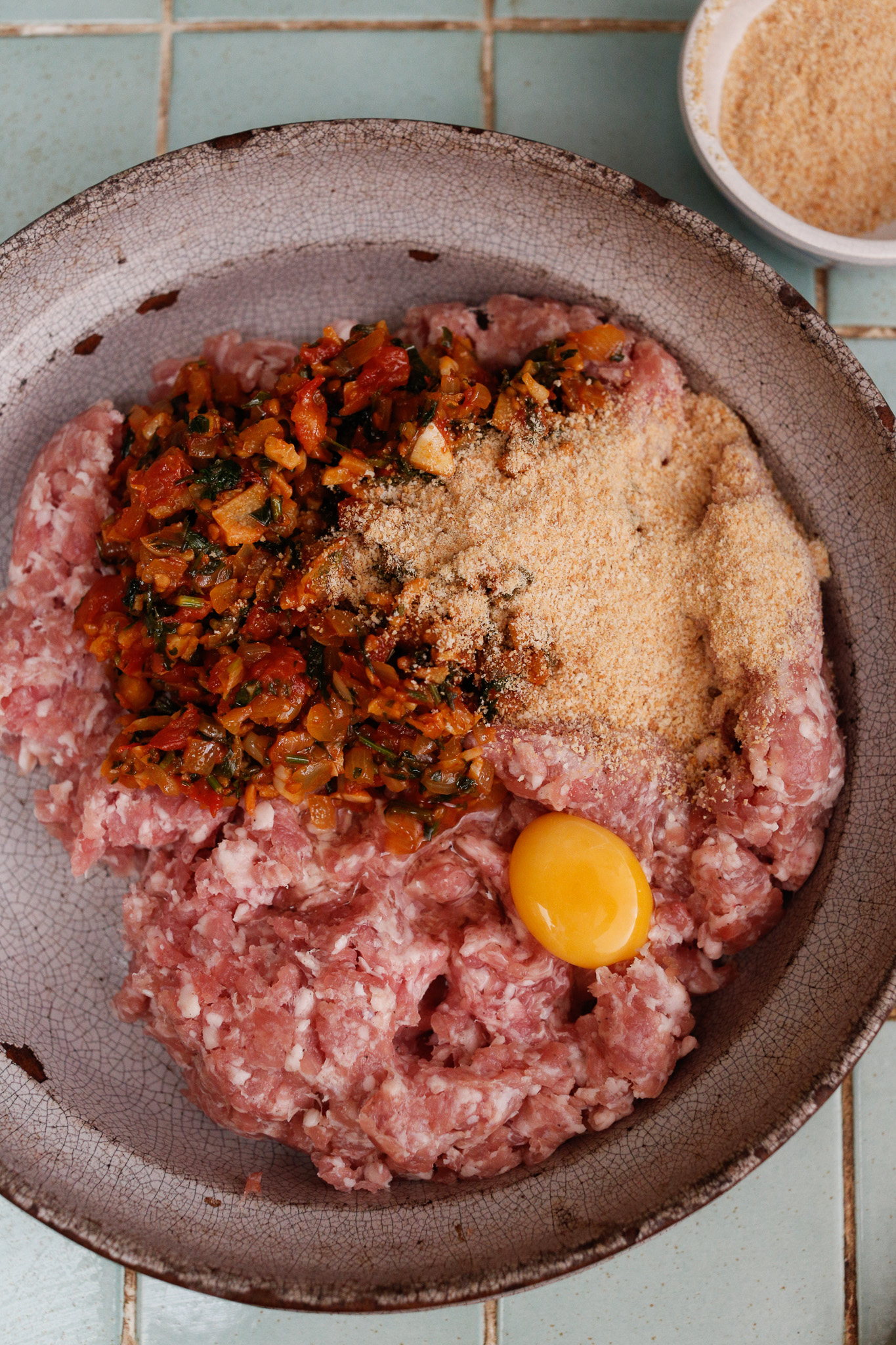 In a large mixing bowl add your meat, egg, bread crumbs and finally your onion mixture.