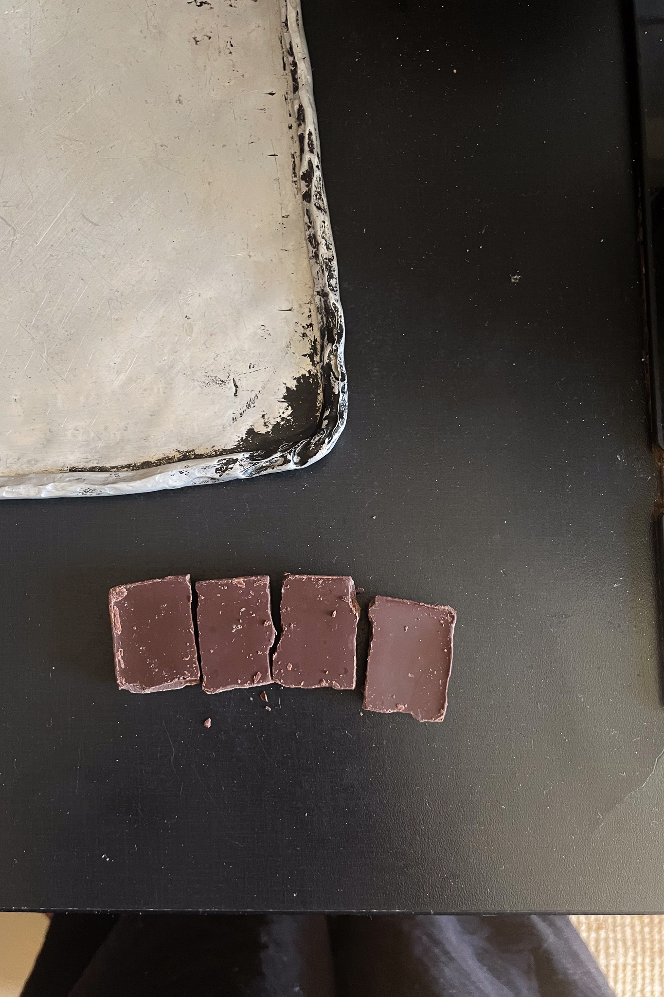 Save 4 pieces of chocolate to add to your melted chocolate at the end to temper the chocolate. A process I don't know much about but will help your chocolate look shiny and work nicely for dipping your fruit.